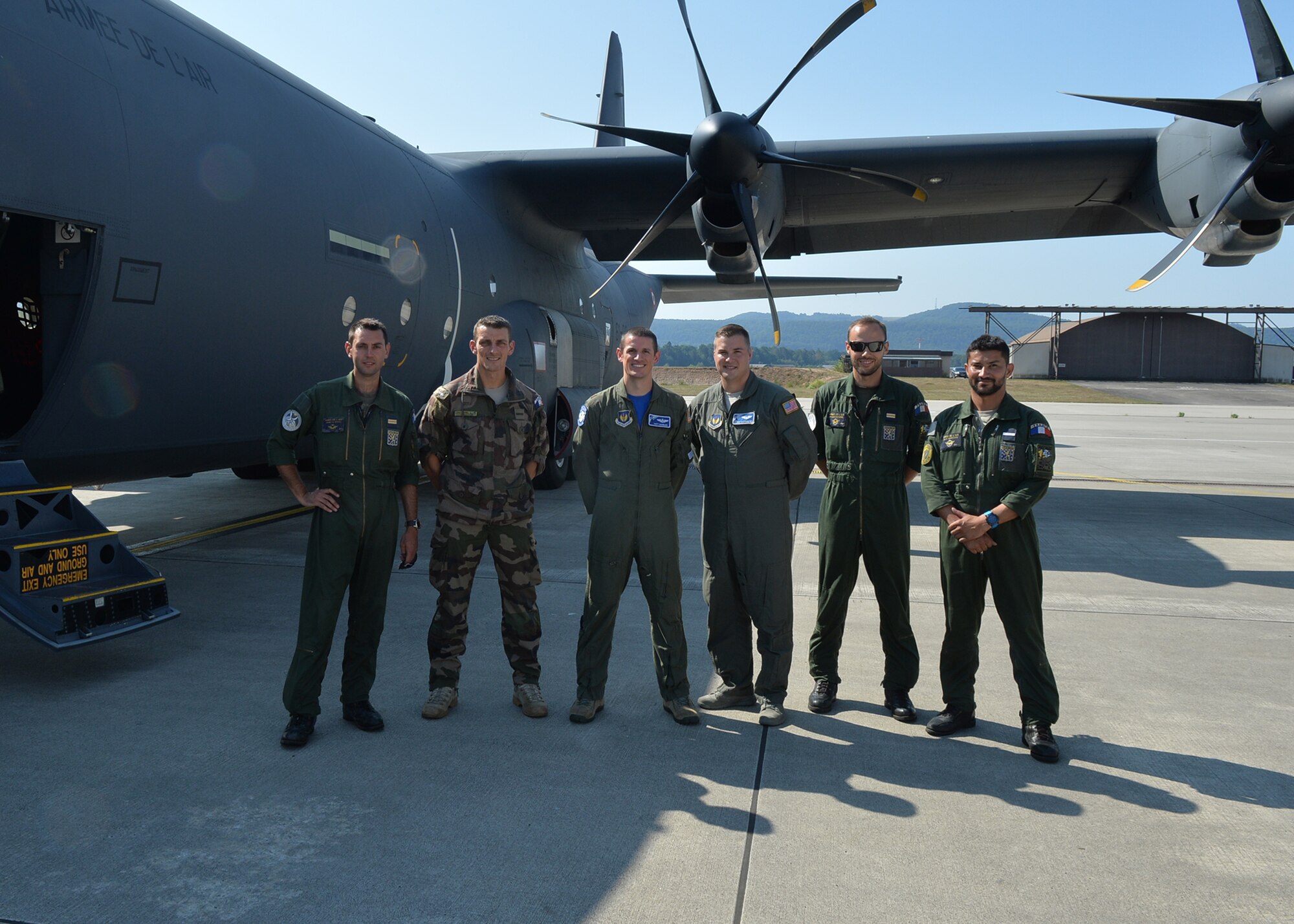 U.S. Air Force Maj. Matthew Hamblen, center-left, 37th Airlift Squadron standards and evaluations chief, and Staff Sgt. Matthew Fry, center-right, 37th AS evaluator loadmaster, conclude a meeting with their French air force counterparts at Ramstein Air Base, Germany, Aug. 3, 2018. Hamblen and Fry worked with the French air force as the French transitioned to the C-130J. (U.S. Air Force photo by Staff Sgt. Jimmie D. Pike)