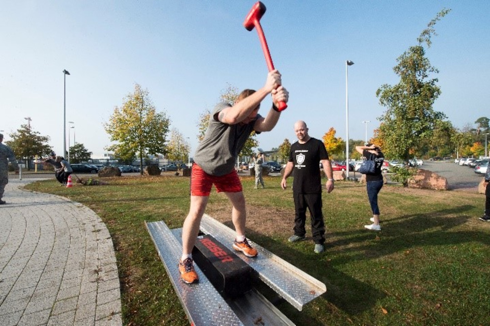 U.S. Army Staff Sgt. Jonathan Partin, Landstuhl Regional Medical Center non-commissioned officer in charge of cardiology, swings a mallet as part of the 86th Civil Engineer Squadron challenge during The Amazing Base competition on Ramstein Air Base, Germany, Oct. 10, 2018. The device, known as a Keiser Sled, is an exercise machine featuring a sliding block on a platform, which is swung at by someone standing above the block to build strength.