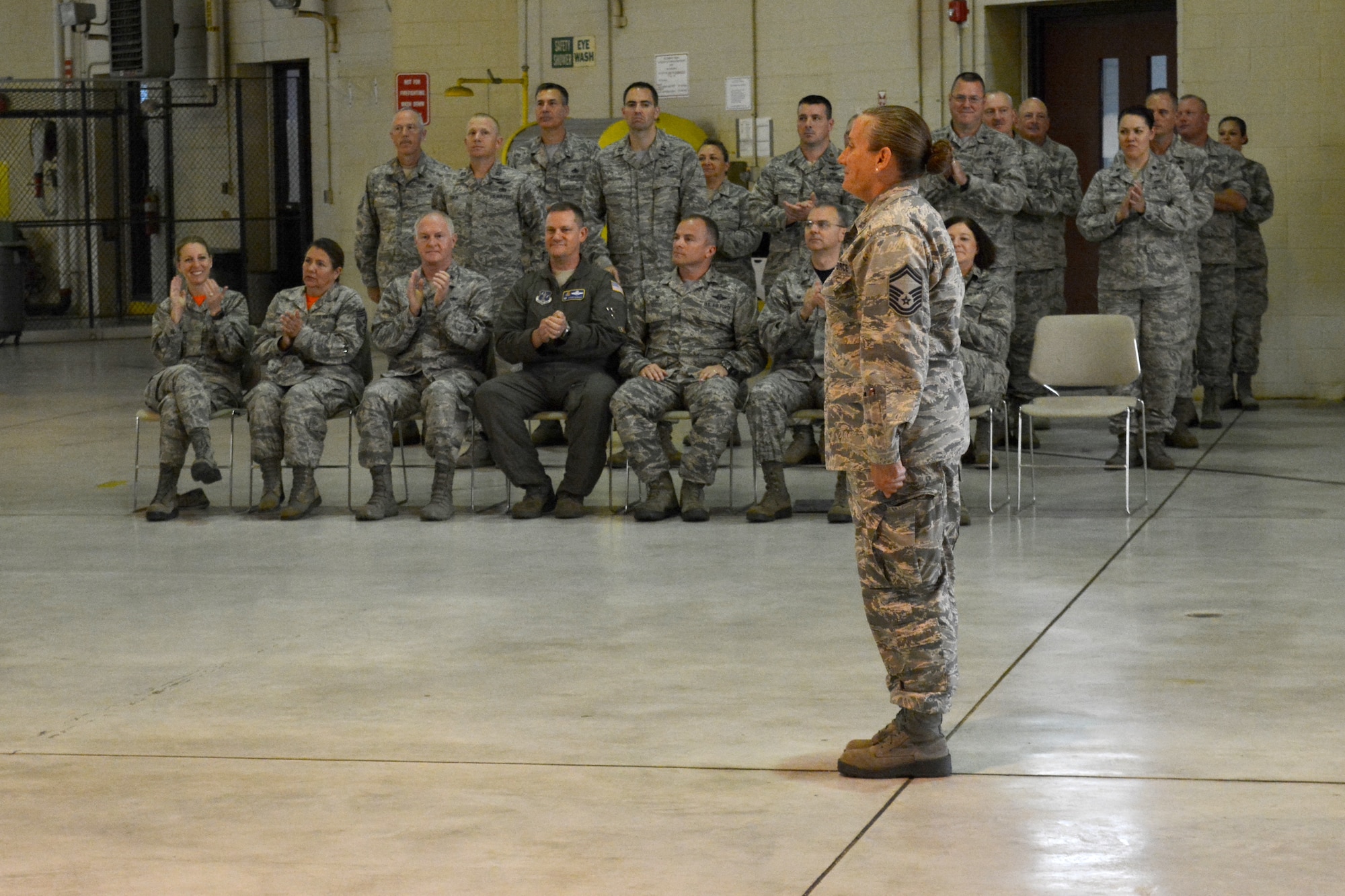 Leadership and peers join in congratulations as U.S. Air Force Chief Master Sgt. Lisa Phillips following her promotion at the North Carolina Air National Guard Base, Charlotte Douglas International Airport, Oct. 13, 2018. Phillips is the first female Chief Master Sgt. ever assigned to the 145th Maintenance Group.