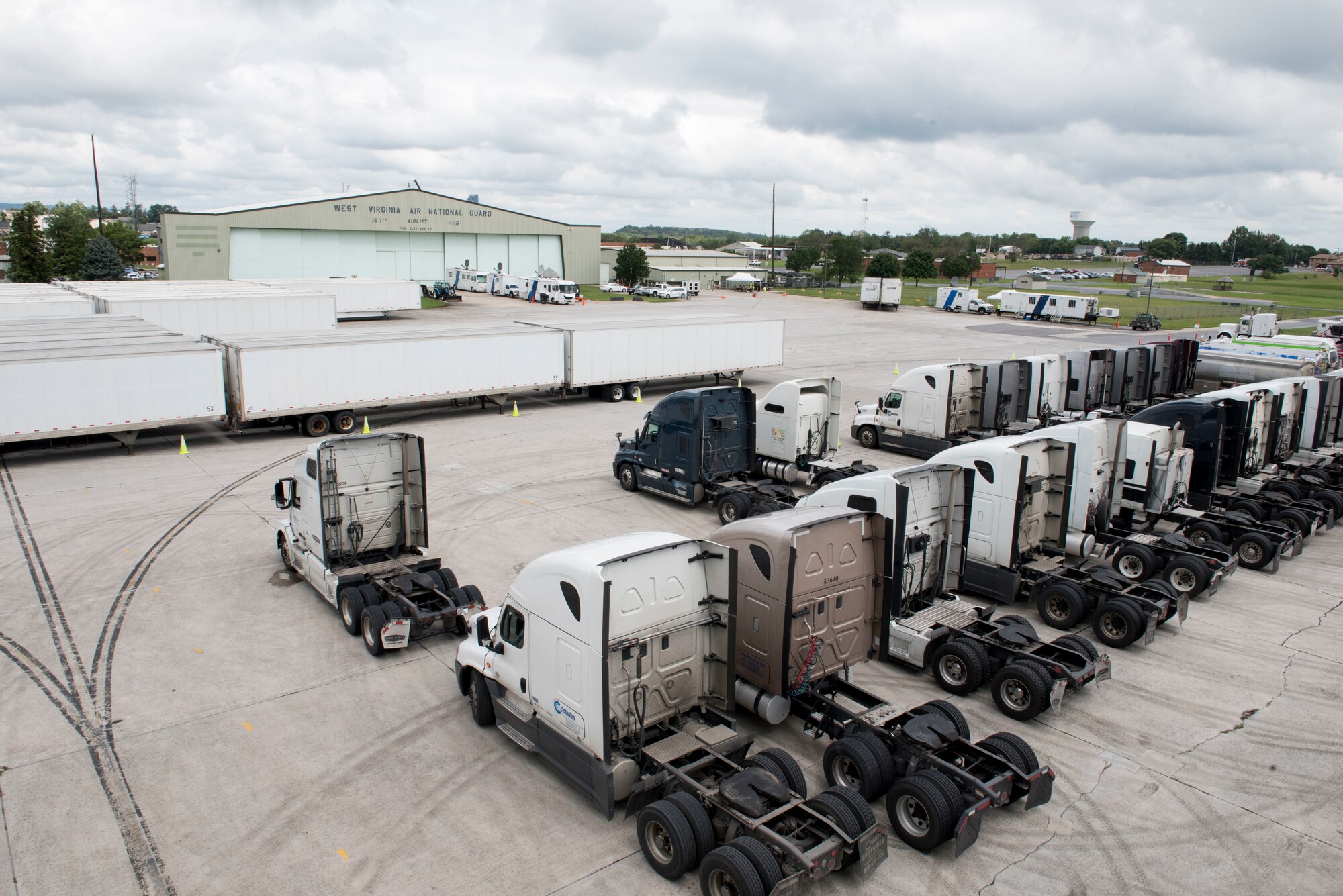 Tractors and trailers full of emergency relief supplies set on stand-by on the transient ramp at the 167th AIrlift Wing, Sept. 13. The Federal Emergency Management Agency staged water, food, cots, blankets, tents and fuel at the wing in preparation for Hurricane Florence. (U.S. Air National Guard photo by Senior Master Sgt. Emily Beightol-Deyerle)