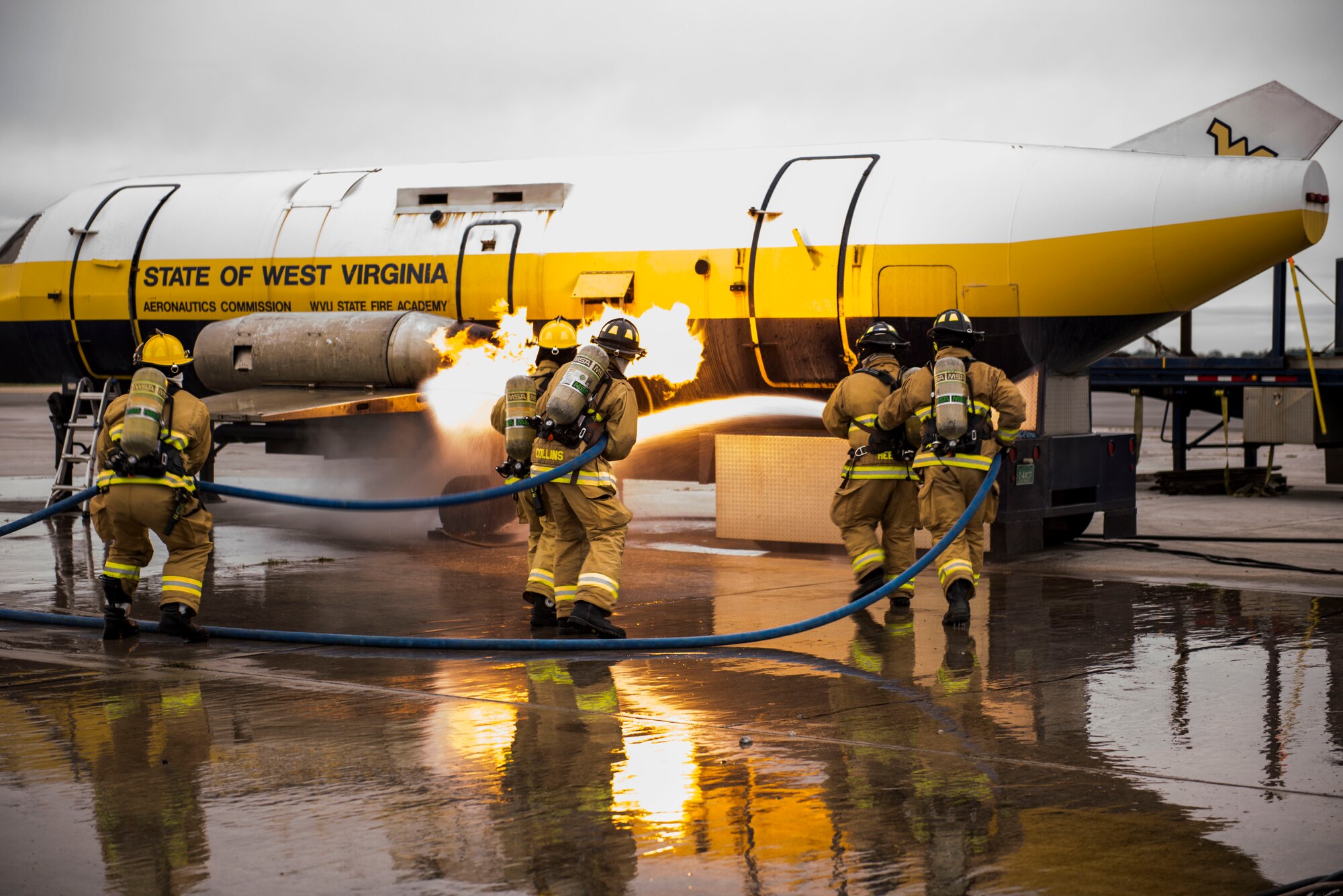 Firefighters from the 167th Airlift Wing extinguish an engine fire on the mobile aircraft fire simulator provided by West Virginia University State Fire Academy during annual Federal Aviation Administration Part 139 Live Fire Training at Martinsburg, W.Va., Oct. 13-14, 2018. (U.S. Air National Guard photo by Staff Sgt. Timothy Sencindiver)