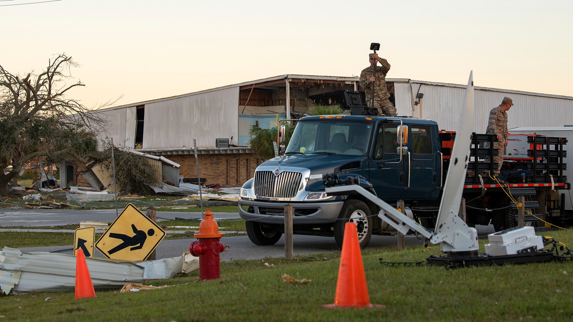 U.S. Air Force Tech Sgt. Ryan Boorman, 290th Joint Communication Support Squadron radio frequency transmissions specialist, works to restore communication capabilities outside the Bay County Government Center in Panama City, Fla., Oct. 13, 2018. The Florida Air National Guard squadron and Joint Communication Service Element, U.S. Transportation Command, both from MacDill Air Force Base, train and deploy together all over the world to rapidly enable Total Force success across the full spectrum of operations. (U.S. Air Force photo by Airman 1st Class Caleb Nunez)
