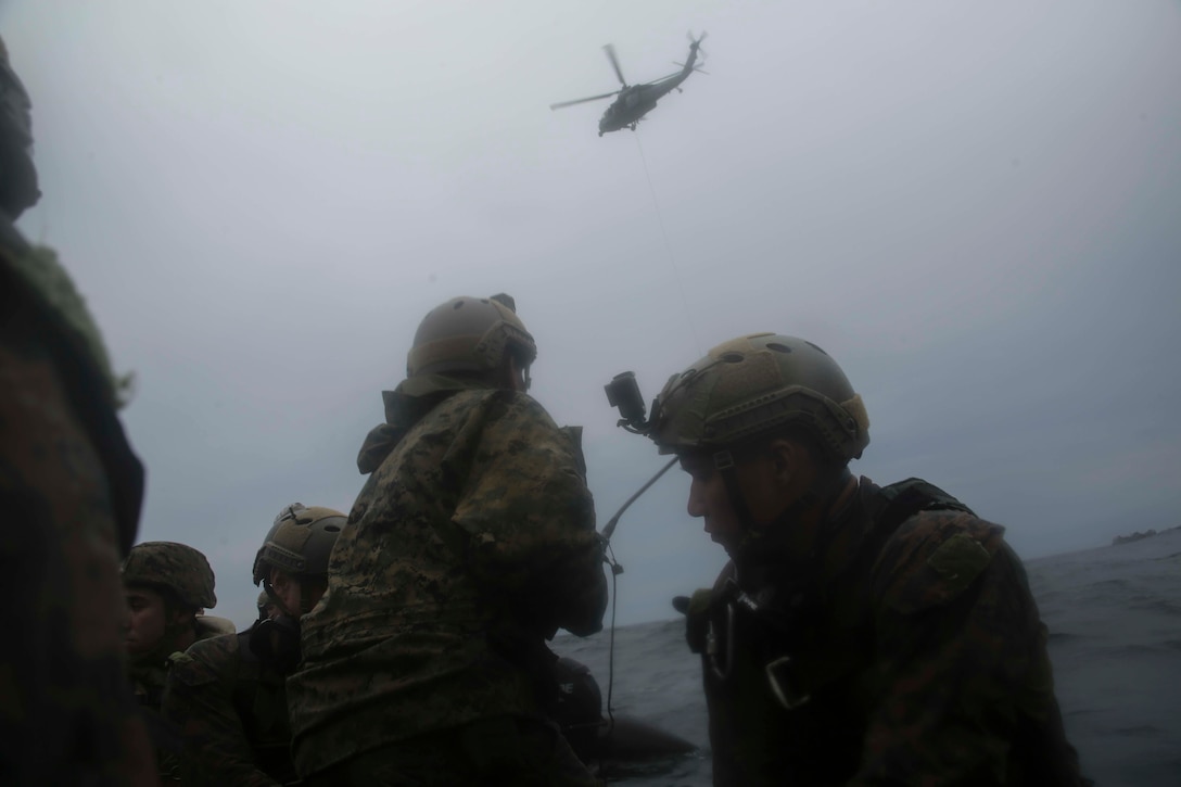 Marines with the 31st Marine Expeditionary Unit’s Amphibious Reconnaissance Platoon move towards a U.S. Navy MH-60S Seahawk helicopter during Helocast and Special Patrol Insertion and Extraction training, underway in the East China Sea, Oct. 14, 2018. The Seahawk belongs to Helicopter Sea Combat Squadron 25. Helocasting and SPIE operations allow the recon Marines to enter and exit tactical landing zones that are inaccessible to helicopters during amphibious operations. The 31st MEU, the Marine Corps’ only continuously forward-deployed MEU, provides a flexible force ready to perform a wide-range of military operations in the Indo-Pacific region.