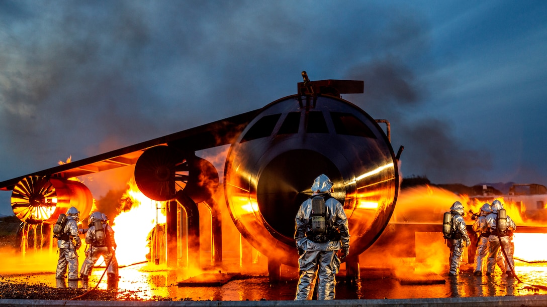 U.S. Marine Corps Sgt. Zachary Campbell, aircraft rescue and firefighting specialist with Headquarters and Headquarters Squadron, supervises fire containment drills at Marine Corps Air Station, Iwakuni, Japan, Oct. 12, 2018. The training was conducted in order to maintain proficiency extinguishing aircraft fires in support of the air station's mission of launching and recovering aircraft. Aircraft Rescue and Firefighting is a special category of firefighting that involves the response, hazard mitigation, evacuation and possible rescue of passengers and crew of an aircraft involved in a ground emergency.