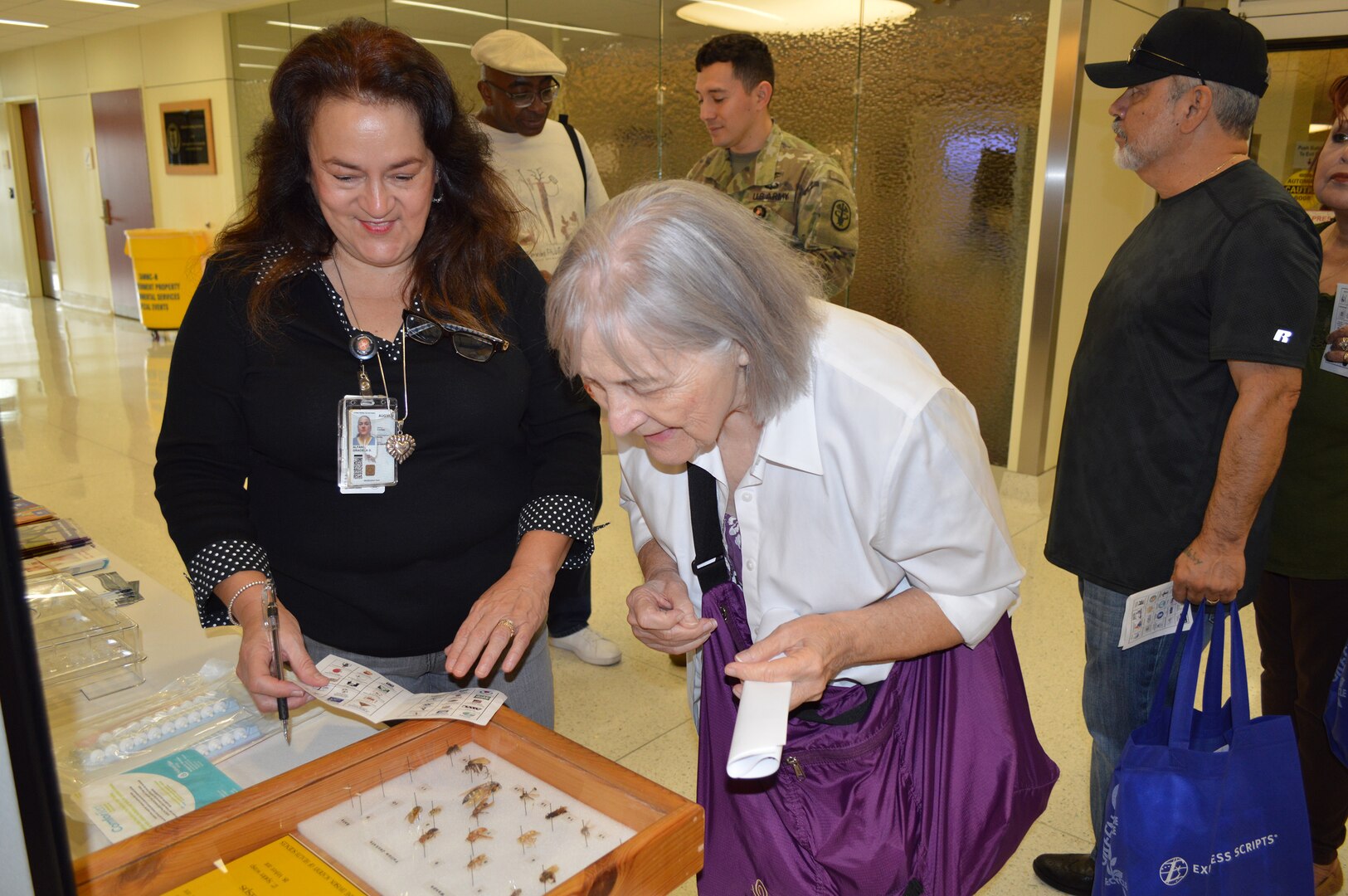 Graciela Alfano (left), licensed vocational nurse, shows Joann Dick, a regular attendee, different insects that can cause various allergy reactions during the Military Retiree Appreciation Day at Brooke Army Medical Center Medical Mall Oct. 14, 2017. Military retirees and service members who are about to retire can find out about useful programs and benefits at Military Retiree Appreciation Day Oct. 20, 2018 from 8 a.m. to noon at the Brooke Army Medical Center Medical Mall.