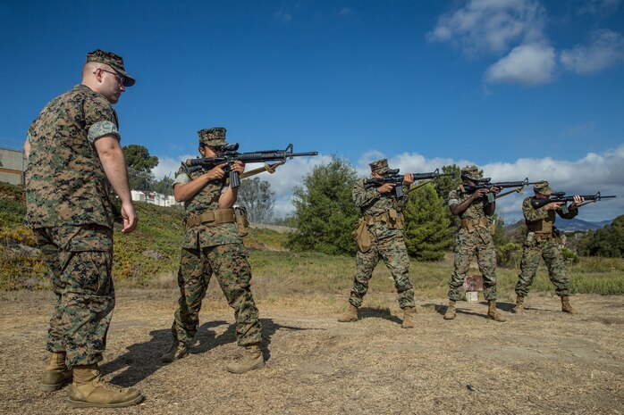 U.S. Marine Corps Sgt. Garald John, combat marksmanship trainer, Headquarters and Support Battalion, Marine Corps Base Camp Pendleton, assesses Marines while they “snap in” at Marine Corps Base Camp Pendleton, California, Oct. 5, 2018. "Snapping in" is the term used to describe practicing dry-firing with an empty weapon before live-firing.
