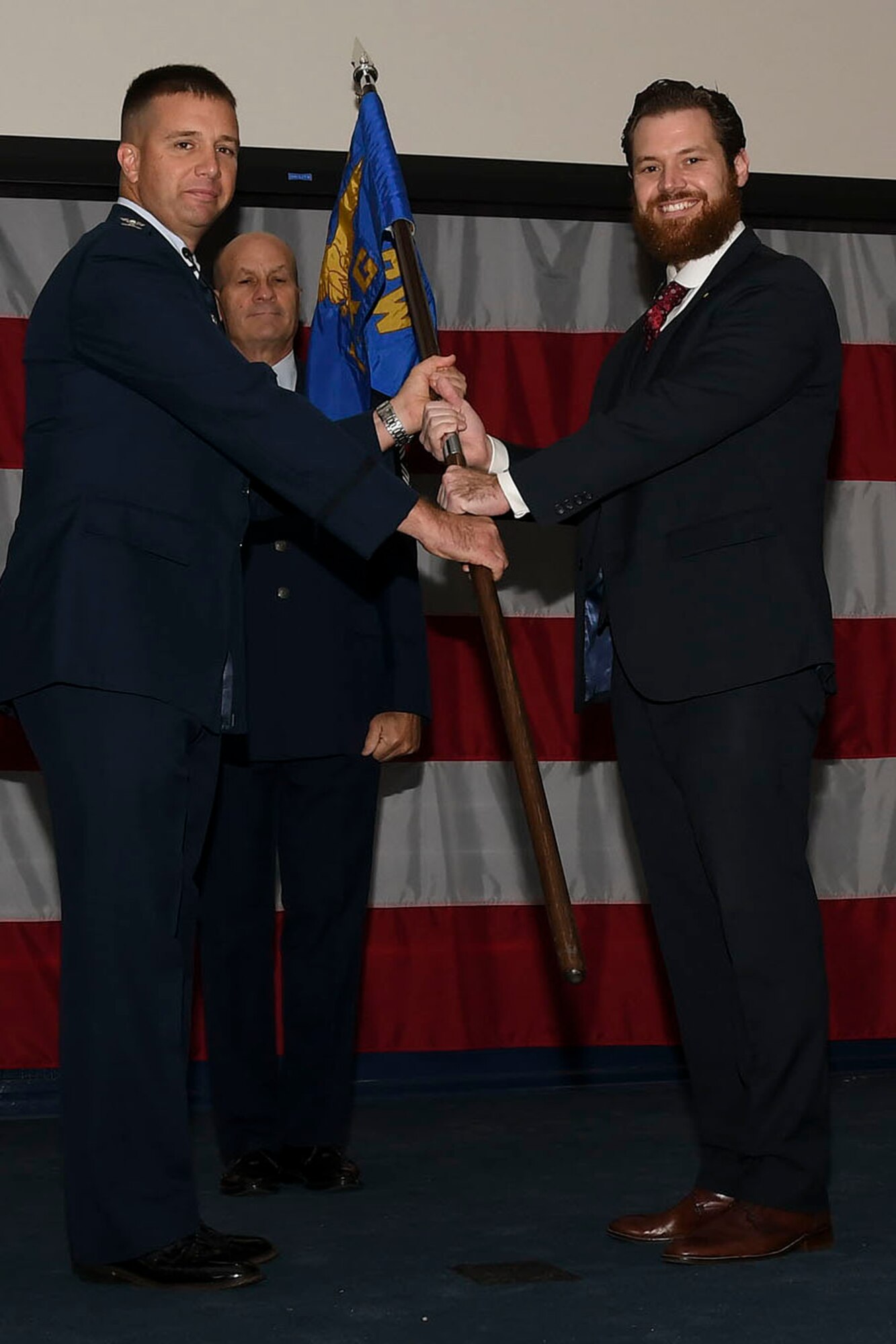 Col. Casey Cooley, 307th Maintenance Group commander, presents the units guidon to Christopher Steinsholt during an honorary commander’s induction ceremony at Barksdale Air Force Base, Louisiana, Oct. 13, 2018.   Steinsholt, a former B-52 Stratofortress crew chief, became the honorary commander of the unit during the event.  (U.S. Air Force photo by Staff Sgt. Callie Ware)