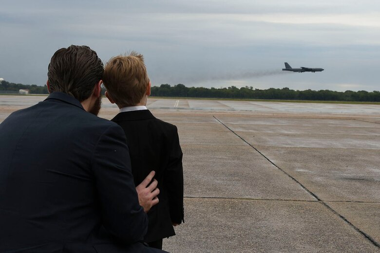 Christopher Steinsholt, 307th Maintenance Group honorary commander, and his son, Benjamin, watch a B-52 Stratofortress take off from Barksdale Air Force Base, Louisiana, Oct. 13, 2018.  The two were enjoying a B-52 static tour when they spied another jet leaving on a routine training mission.  Earlier in the day, Christopher Steinsholt was inducted as the 307th MXG honorary commander.  He is a former B-52 crew chief with 10 years of service in the Air Force. (U.S. Air Force photo by Staff Sgt. Callie Ware)