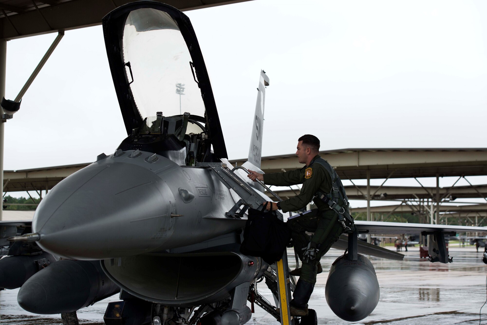 A U.S. Air Force pilot assigned to the 79th Fighter Squadron (FS) climbs into an F-16 Fighting Falcon at Shaw Air Force Base, S.C., Oct. 10, 2018.
