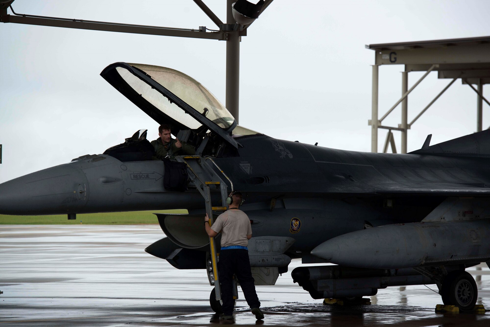 A U.S. Air Force pilot assigned to the 79th Fighter Squadron completes pre-flight procedures with a crew chief assigned to the 20th Aircraft Maintenance Squadron at Shaw Air Force Base, S.C., Oct. 10, 2018.