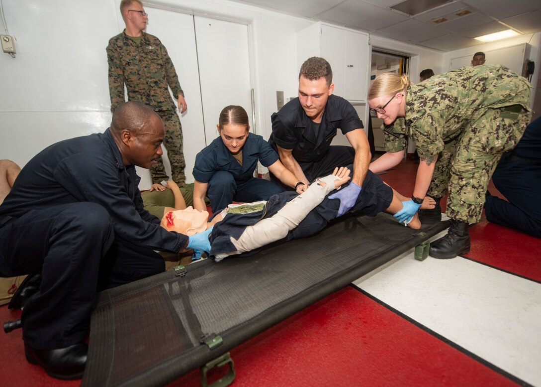 Sailors aboard the hospital ship USNS Comfort conduct stretcher bearer training during a mass casualty drill.