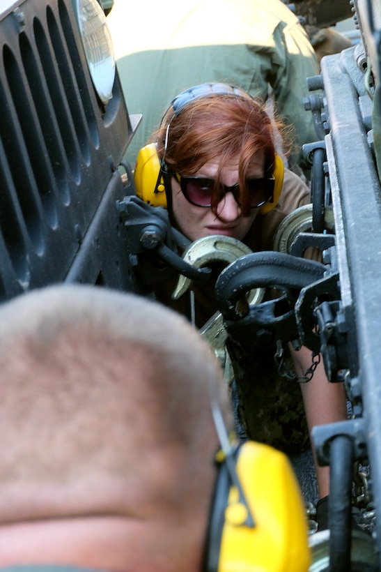 A U.S. Navy Sailor onboard a Landing Craft Air Cushion secures U.S. Marine Corps vehicles to the deck with chains at Mile Hammock Bay, Camp Lejeune, North Carolina, Oct. 5, 2018 in preparation to embark Marines and vehicles aboard USS Iwo Jima (LHD 7) during Type Commander Amphibious Training. TCAT allows the 24th Marine Expeditionary Unit, their subordinate units, and the U.S. Navy’s Iwo Jima Amphibious Ready Group to rehearse ship to shore maneuver and expeditionary command and control prior to exercise Trident Juncture 2018. The goal of TCAT is to increase unit and individual proficiency during amphibious operations. The Marines are with 2nd Battalion, 2nd Marines, 24th Marine Expeditionary Unit.  (U.S. Marine Corps photo by Gunnery Sgt. Robert Durham/released)