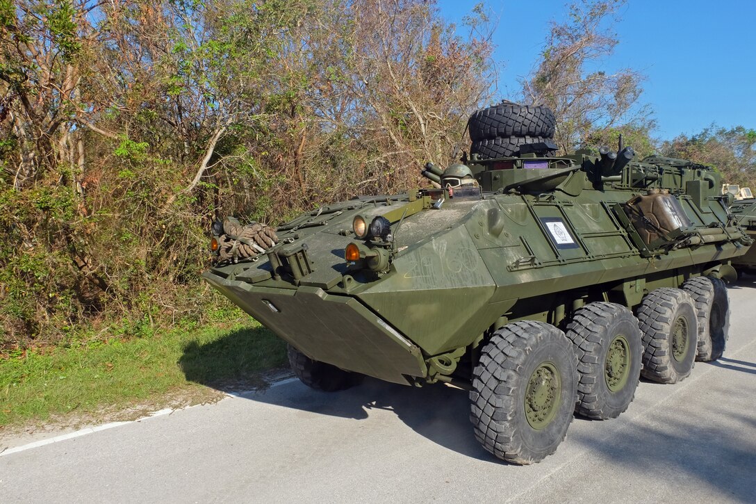 A U.S. Marine Light Armored Vehicle crewman prepares to drive onto the loading ramp of a Landing Craft Air Cushion at Mile Hammock Bay, Camp Lejeune, North Carolina, Oct. 5, 2018 during Type Commander Amphibious Training. TCAT allows the 24th Marine Expeditionary Unit, their subordinate units, and the U.S. Navy’s Iwo Jima Amphibious Ready Group to rehearse ship to shore maneuver and expeditionary command and control prior to exercise Trident Juncture 2018. The goal of TCAT is to increase unit and individual proficiency during amphibious operations. The LAVs are with 2nd Light Armored Reconnaissance Battalion, 24th Marine Expeditionary Unit.  (U.S. Marine Corps photo by Gunnery Sgt. Robert Durham/released)