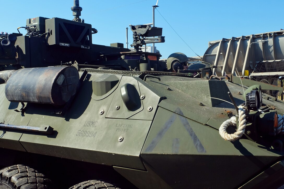 A U.S. Marine Light Armored Vehicle crewman drives onto the loading ramp of a Landing Craft Air Cushion at Mile Hammock Bay, Camp Lejeune, North Carolina, Oct. 5, 2018 during Type Commander Amphibious Training. TCAT allows the 24th Marine Expeditionary Unit, their subordinate units, and the U.S. Navy’s Iwo Jima Amphibious Ready Group to rehearse ship to shore maneuver and expeditionary command and control prior to exercise Trident Juncture 2018. The goal of TCAT is to increase unit and individual proficiency during amphibious operations. The LAVs are with 2nd Light Armored Reconnaissance Battalion, 24th Marine Expeditionary Unit.  (U.S. Marine Corps photo by Gunnery Sgt. Robert Durham/released)