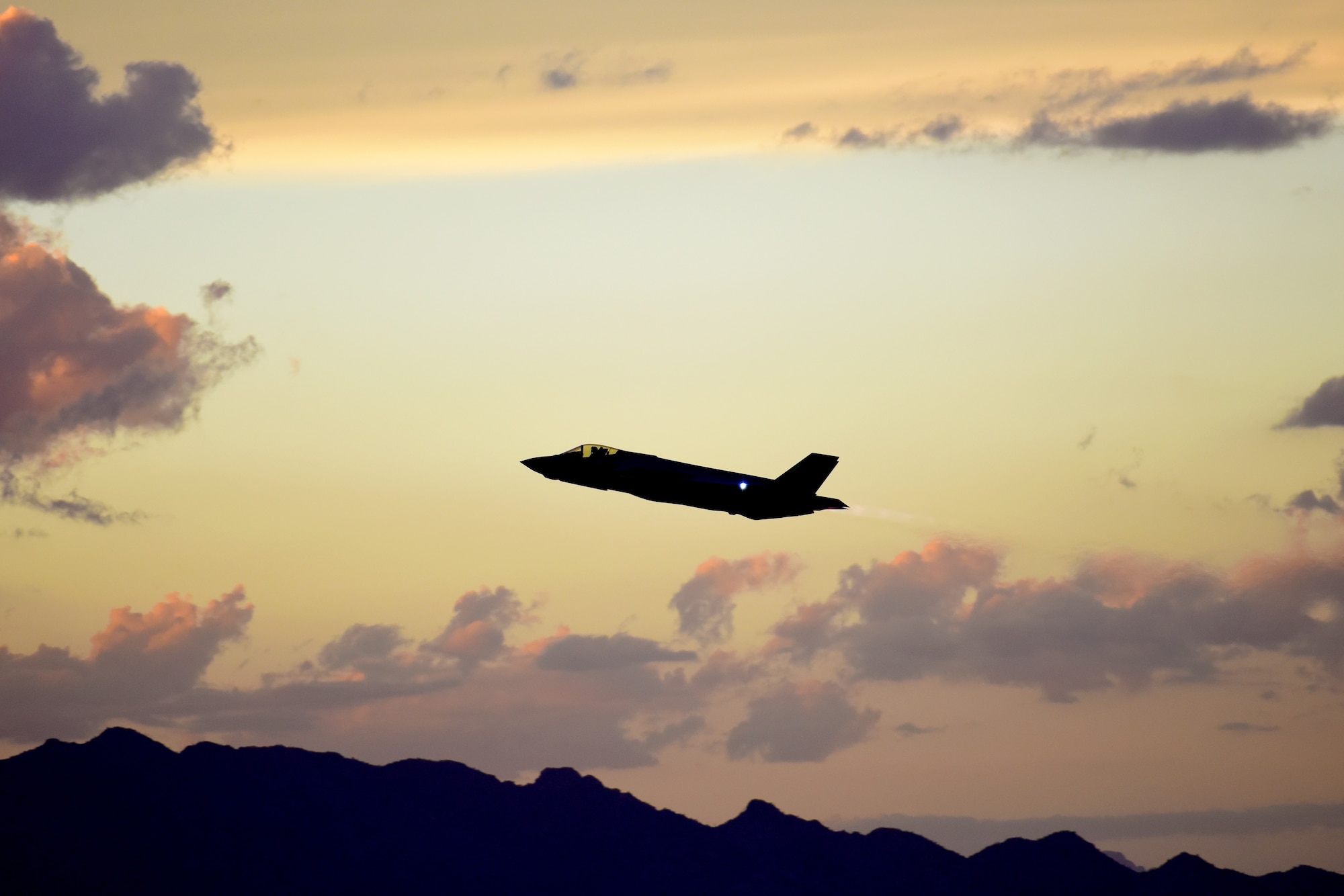 An F-35A Lightning II ascends over the mountains around Luke Air Force Base, Ariz., Oct. 11, 2018. The pilot training courses at Luke include a night flying block which lasts for a few weeks. (U.S. Air Force photo by Senior Airman Ridge Shan)