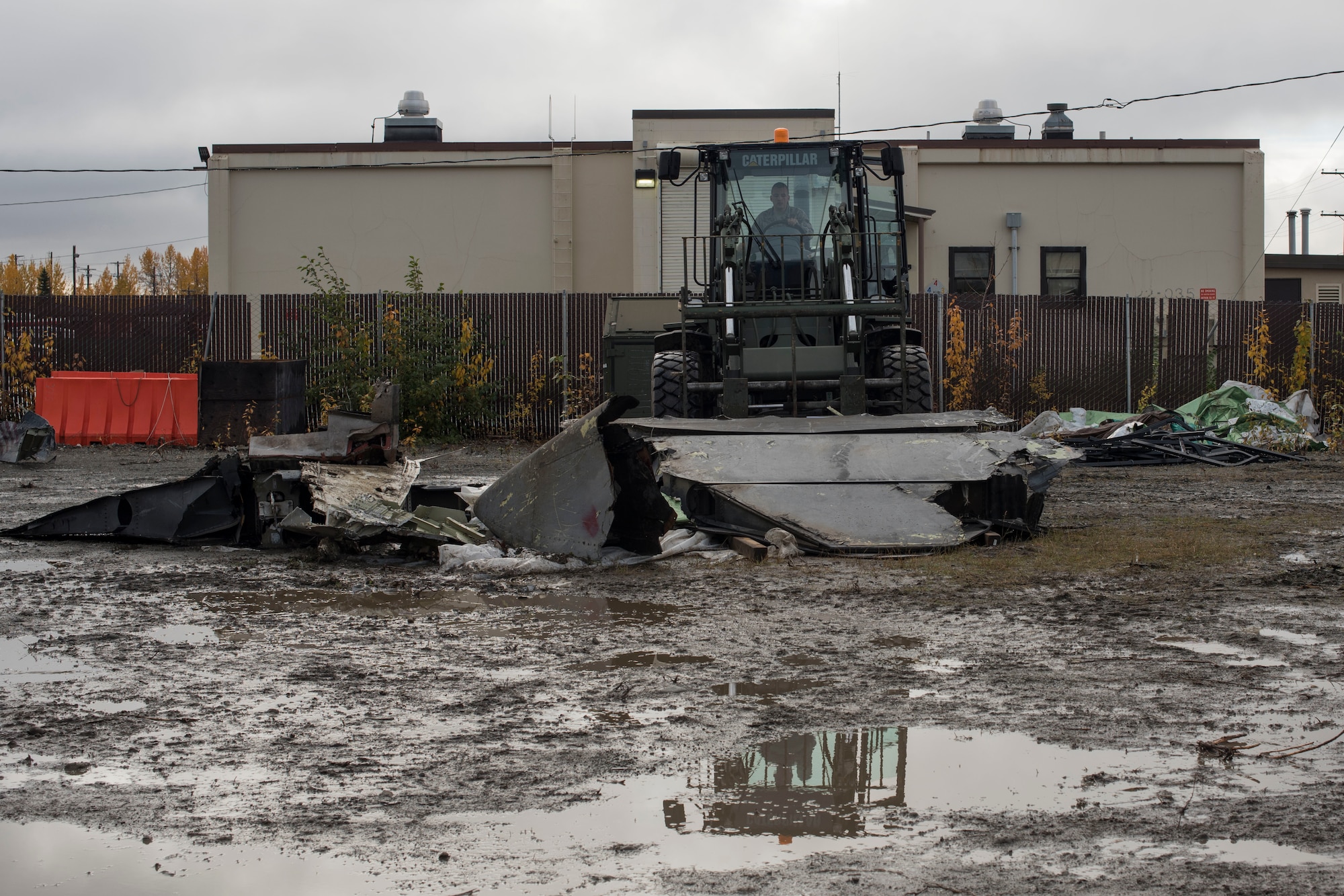 U.S. Air Force Senior Airman Christopher Hershberger, a 773d Logistics Readiness Squadron vehicle operator, picks up part of a wing using a 10k all-terrain forklift to remove wreckage debris at Joint Base Elmendorf-Richardson, Alaska, Sept. 28, 2018. Hershberger was part of a large wreckage disposal team whose mission was to remove debris from the fatal crash of the Sitka 43 C-17 Globemaster III that had been stored at JBER since 2010.