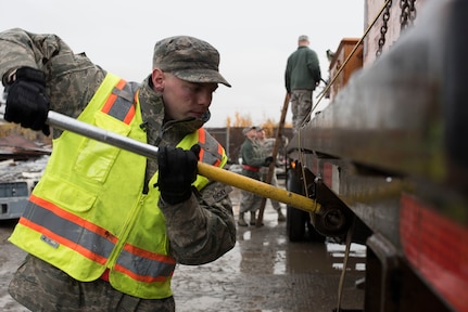 U.S. Air Force Senior Airman Jesse Richey, a 773d Logistics Readiness Squadron vehicle operator, straps down cargo at Joint Base Elmendorf-Richardson, Alaska, Sept. 28, 2018. Richy was part of a large wreckage disposal team whose mission was to remove debris from the fatal crash of the Sitka 43 C-17 Globemaster III that had been stored at JBER since 2010.