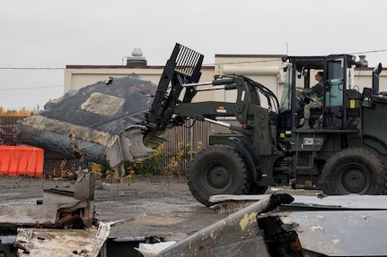 U.S. Air Force Airman 1st Class Pamela Proteau, a 773d Logistics Readiness Squadron vehicle operator, picks up part of a wing using a 10k all-terrain forklift to remove wreckage debris at Joint Base Elmendorf-Richardson, Alaska, Sept. 28, 2018. Proteau was part of a large wreckage disposal team whose mission was to remove debris from the fatal crash of the Sitka 43 C-17 Globemaster III that had been stored at JBER since 2010. After multiple shipments, the ‘Sitka 43’ wreckage is finding a new purpose at the Air Force Safety Center (AFSEC) Crash Lab at Kirtland Air Force Base, N.M.