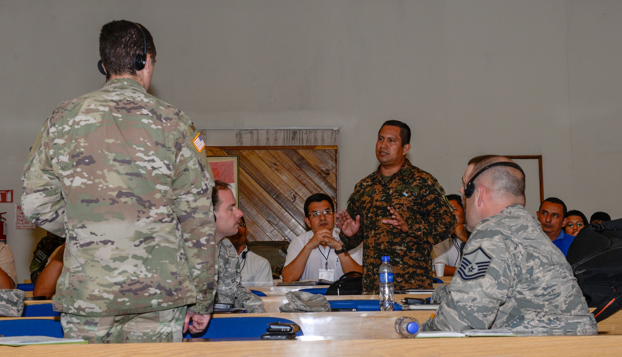 El Salvador Army Capt. Leonel Maye, center standing, artillery commander for La Fuerza Armada de El Salvador, discusses cyber security and cyber defense with the New Hampshire National Guard team visiting San Salvador, El Salvador, September 25, 2018. The discussions are part of the ongoing partnership between New Hampshire and El Salvador under the National Guard State Partnership Program. (N.H. National Guard photo by Tech. Sgt. Aaron Vezeau)