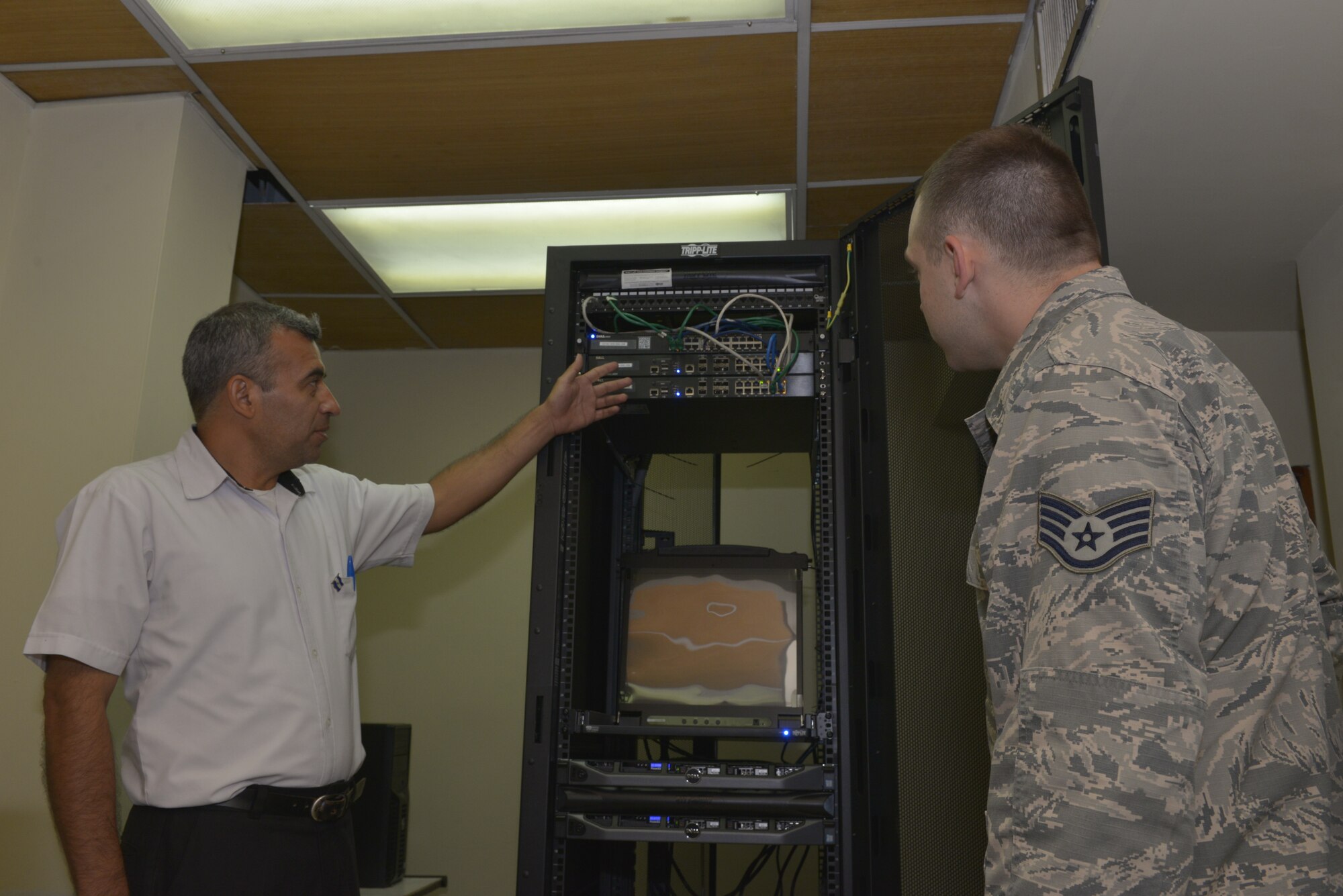 Arnoldo Inocencio Rivas Molina, a force development sustainment systems engineer with La Fuerza Armada de El Salvador, shows off a virtual cyber training system to U.S. Air Force Staff Sgt. Alan Dwyer, a cyber systems operations specialist assigned to the 157th Communications Flight, New Hampshire Air National Guard, San Salvador, El Salvador, Sept. 27, 2018. Dwyer is part of a multi-state National Guard State Partnership Program, headed by the New Hampshire National Guard, in order to help assess and determine recommendations for the Salvadoran Army as they stand up a cyber security unit. (N.H. Air National Guard photo by Tech. Sgt. Aaron Vezeau)