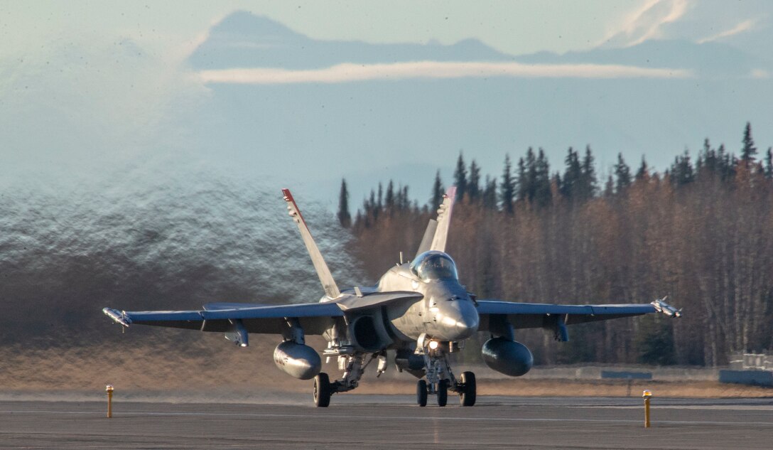 A U. S. Marine Corps F/A-18C Hornet assigned to Marine Fighter Attack Squadron (VMFA) 232, Marine Aircraft Group 11, 3rd Marine Aircraft Wing, proceeds down the Eielson Air Force Base, Alask,a flight line before flight as a part of exercise Red Flag-Alaska 19-1, Oct. 8, 2018. Red Flag is a series of U.S. Pacific Air Force commander-directed field training exercise for U.S. and coalition forces to provide a realistic joint offensive counter-air, interdiction, close air support and large-force employment training in a simulated combat environment. (U.S. Marine Corps photo by Sergeant Maria A. Noyola)
