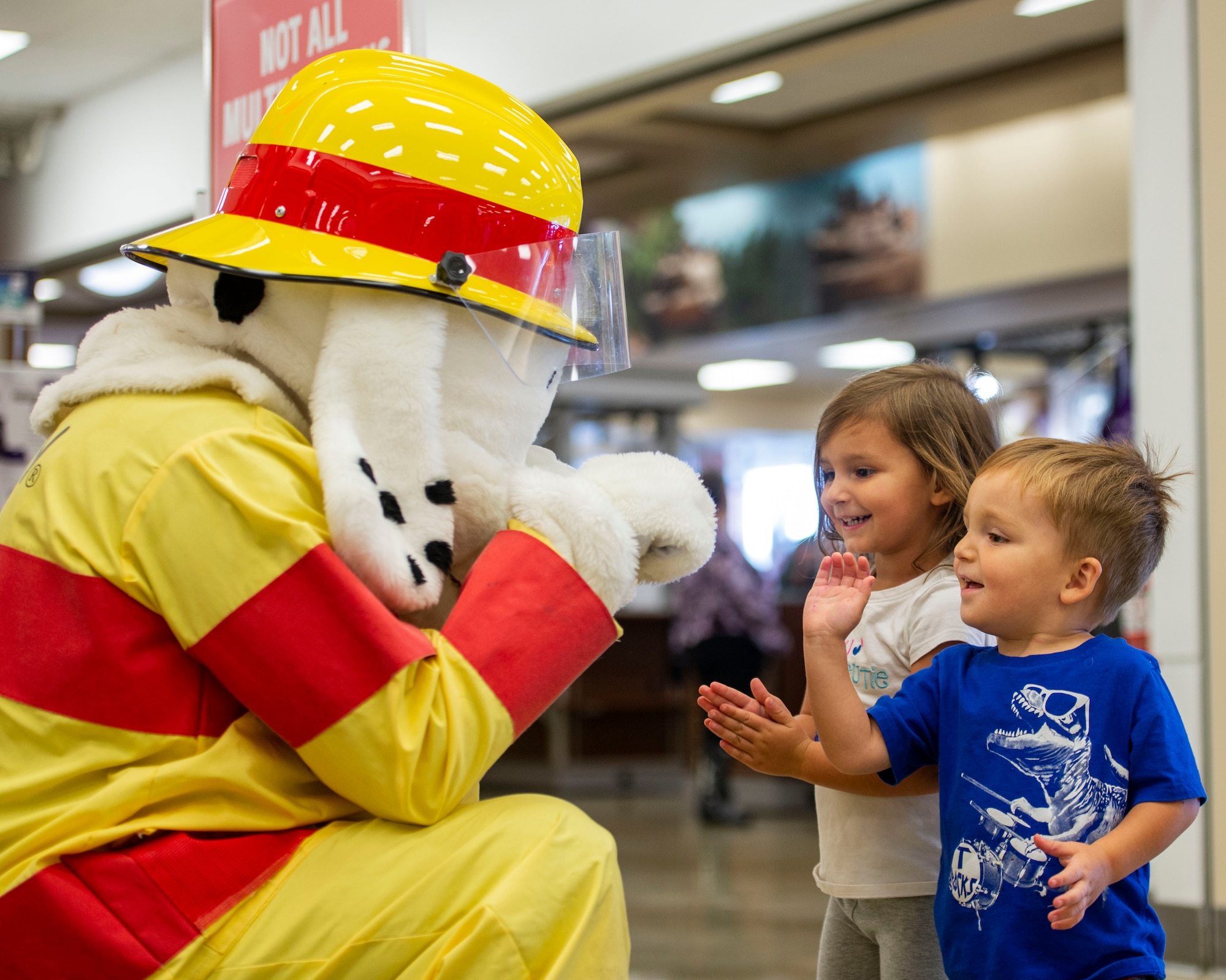 Sparky the fire dog interacts children during a visit to the Army and Air Force Exchange Service at Scott Air Force Base as part of 2018 National Fire Prevention Week, Oct. 10. Throughout the week the fire department visited the Child Development Centers, Scott Elementary School, the Scott Youth Center, hosted a puppet show at the base library, and held an open house and Fall Festival at Fire Station 2 on base. (U.S. Air Force photo by Airman 1st Class Chad Gorecki)