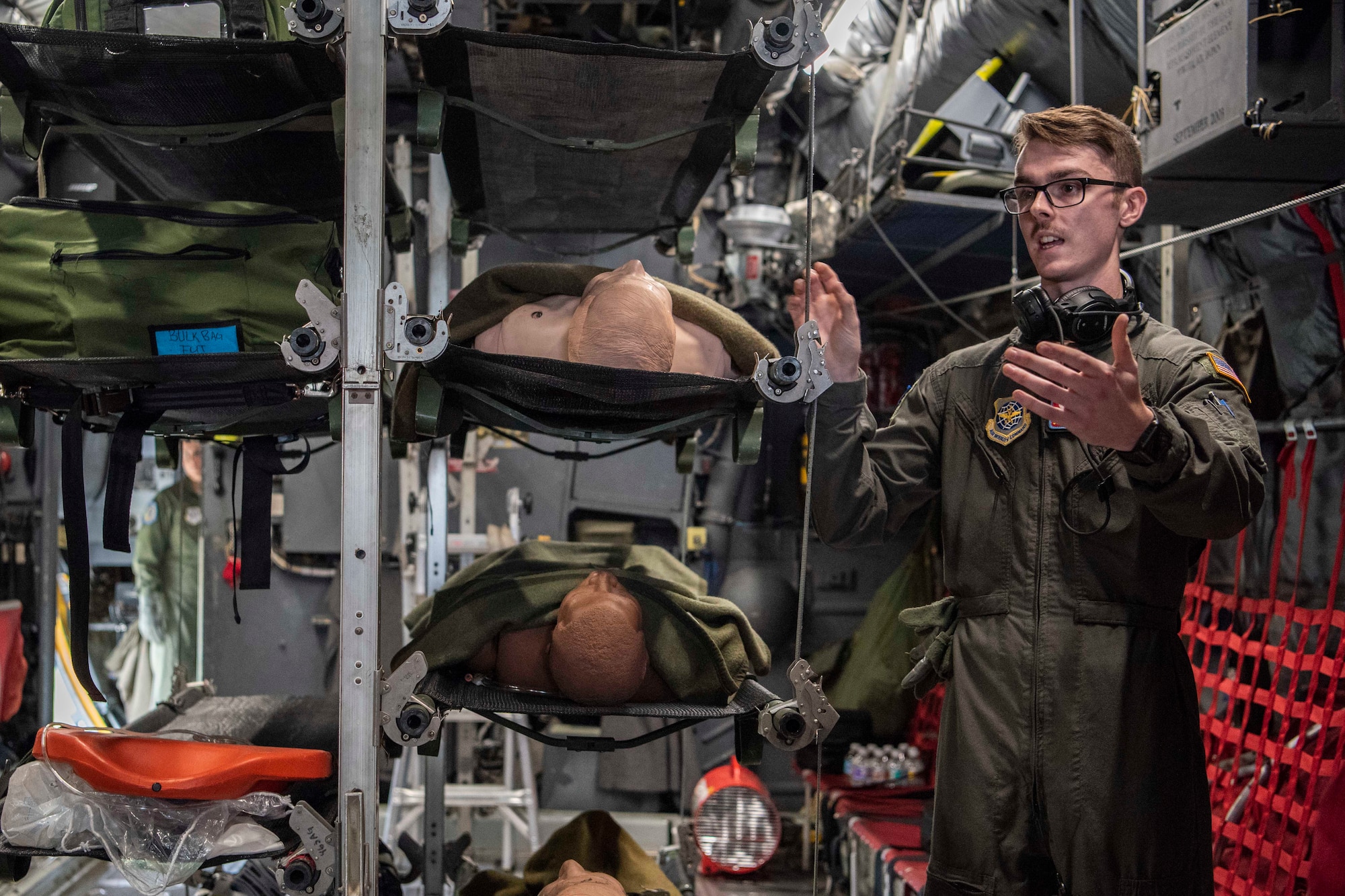 Senior Airman Brannon Tullos, 375th Aeromedical Evacuation Squadron, speaks about the capabilities of a C-130 Globemaster fuselage trainer Oct. 12, 2018 at Scott Air Force Base, Illinois. The fuselage trainer provides a controlled environment where the 375th AES can schedule lifelike, high-fidelity task training and mission simulations. (U.S. Air Force photo by Senior Airman Melissa Estevez)