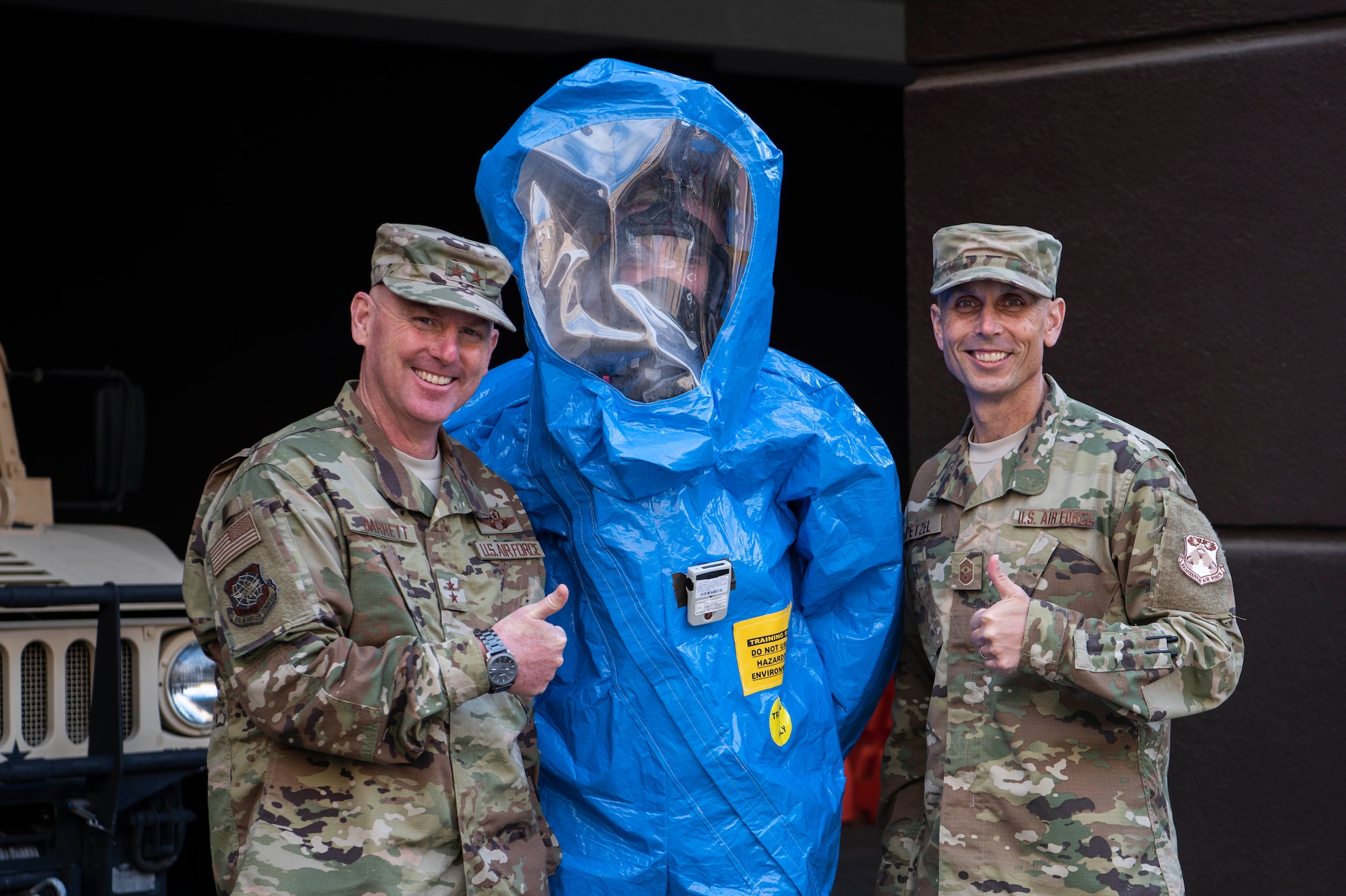 Maj. Gen. Sam Barrett, 18th Air Force commander, and Chief Master Sgt. Todd Petzel, 18th AF command chief, pose for a photo with an Airman from the 375th Medical Group bioenvironmental health technician during a three-day tour Oct. 10 - 13, 2018 at Scott Air Force Base, Illinois. The commander and command chief were able to learn from various Airmen about what they do and how they support the greater mission. (U.S. Air Force photo by Senior Airman Melissa Estevez)