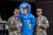 Maj. Gen. Sam Barrett, 18th Air Force commander, and Chief Master Sgt. Todd Petzel, 18th AF command chief, pose for a photo with an Airman from the 375th Medical Group bioenvironmental health technician during a three-day tour Oct. 10 - 13, 2018 at Scott Air Force Base, Illinois. The commander and command chief were able to learn from various Airmen about what they do and how they support the greater mission. (U.S. Air Force photo by Senior Airman Melissa Estevez)