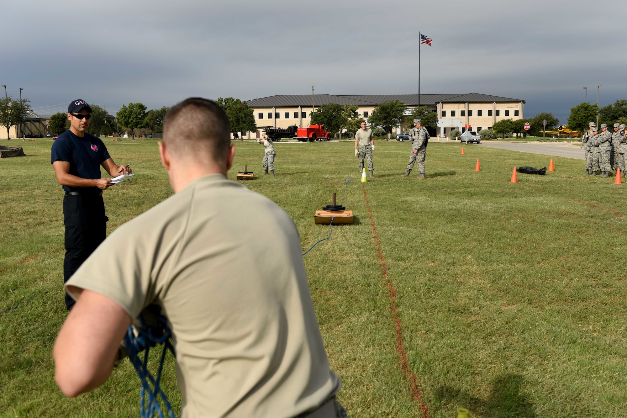 U.S. Air Force Staff Sgt. Zachery Hunsinger, 316th Training Squadron instructor, pulls a weighted sled over 100-foot during the 13th Annual Fire Muster on Goodfellow Air Force Base, Texas, Oct. 12, 2018. This exercise simulates how firefighters train to carry heavy objects over long, difficult terrain. (U.S. Air Force photo by Senior Airman Randall Moose/Released)