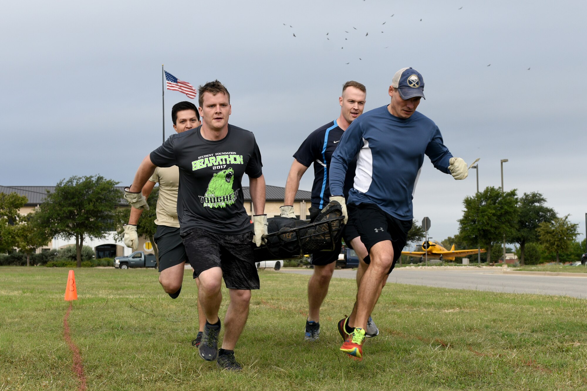 Team “The Gavel” carry a weighted litter over 100-foot during the 13th Annual Fire Muster on Goodfellow Air Force Base, Texas, Oct. 12, 2018. This exercise simulates how firefighters train to carry wounded individuals. (U.S. Air Force photo by Senior Airman Randall Moose/Released)