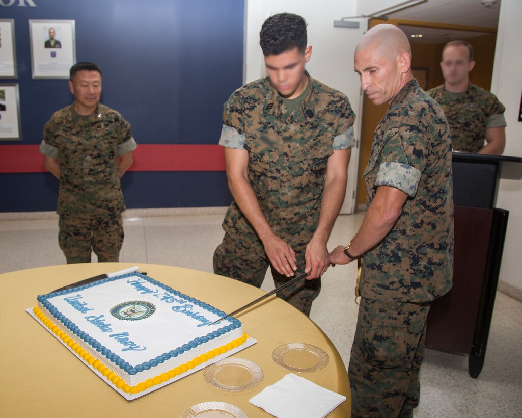 The oldest and youngest Sailors with U.S. Marine Corps Forces, Special Operations Command, cut the ceremonial birthday cake for the Navy’s 243rd birthday at MARSOC Headquarters aboard Marine Corps Base Camp Lejeune, N.C., Oct. 15, 2018.  The oldest Sailor (right) was born in 1968 and the youngest (center) in 1998.  The oldest Sailor passes cake to the youngest Sailor in a tradition that represents the transfer of experience and knowledge.  MARSOC Commander, General Daniel D. Yoo (left), was honored as the guest of honor during the ceremony. (U.S. Marine Corps photo by Cpl. Bryann K. Whitley)
