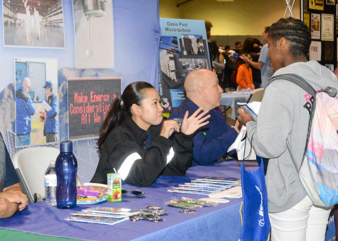 Ashley Vu, an engineer with 412th Civil Engineer Group at Edwards Air Force Base, talks with high school students about her job as an engineer during the 27th annual Salute to Youth career fair at the Antelope Valley Fair and Event Center in Lancaster, California, Oct. 11. (U.S. Air Force photo by Giancarlo Casem)