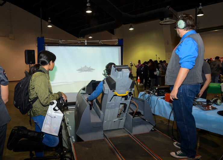 A student flies an aircraft in a flight simulator during the 27th annual Salute to Youth career fair at the Antelope Valley Fair and Event Center in Lancaster, California, Oct. 11. The flight simulator was provided by the 812th Aircraft Instrumentation Test Squadron from Edwards Air Force Base. The simulator helps engineers showcase some of the work they do at Edwards. (U.S. Air Force photo by Giancarlo Casem)