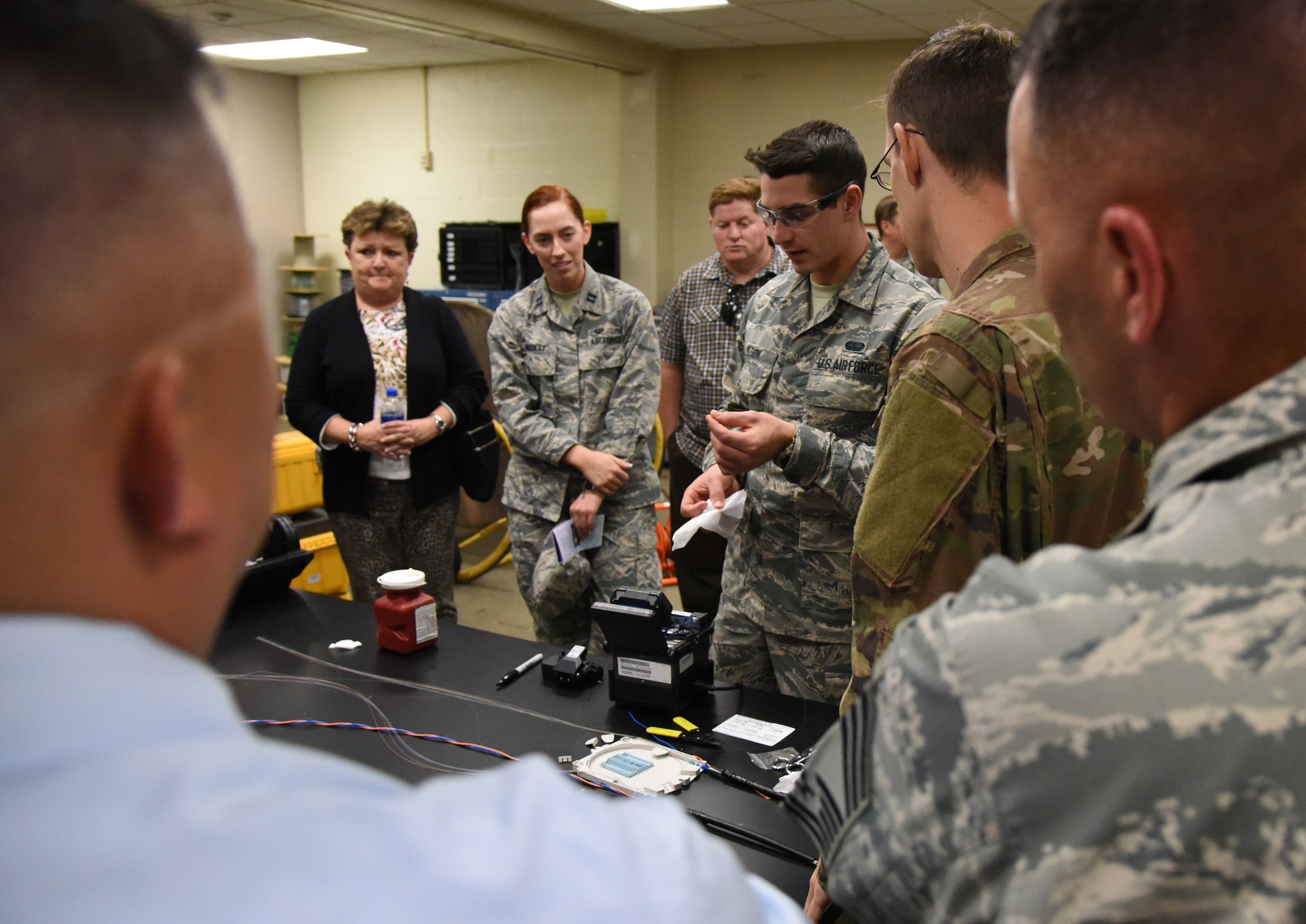 U.S. Air Force Airman Trent Olson, 85th Engineering Installation Squadron cable and antenna systems technician, conducts a cable splicing demonstration during an open house inside Maltby Hall at Keesler Air Force Base, Mississippi, Oct. 11, 2018. Keesler leadership and personnel attended the event to become more familiar with the 85th EIS mission capabilities. (U.S. Air Force photo by Kemberly Groue)