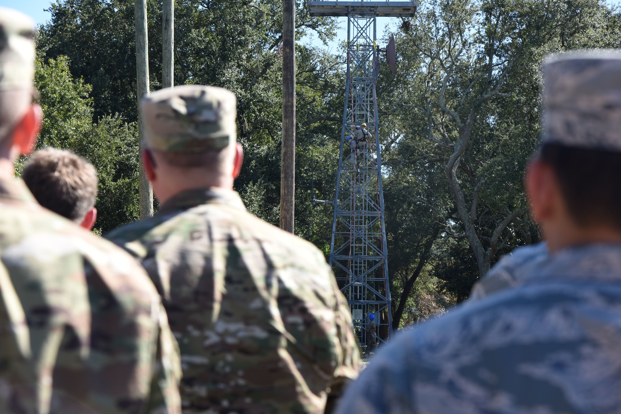 Members of the 85th Engineering Installation Squadron conduct a tower rescue demonstration during the 85th EIS open house outside of Maltby Hall at Keesler Air Force Base, Mississippi, Oct. 11, 2018. Tower rescue and fiber splicing demonstrations were conducted as well as tours inside the tool cage, telecommunications lab and the electromagnetic lab.  (U.S. Air Force photo by Kemberly Groue)