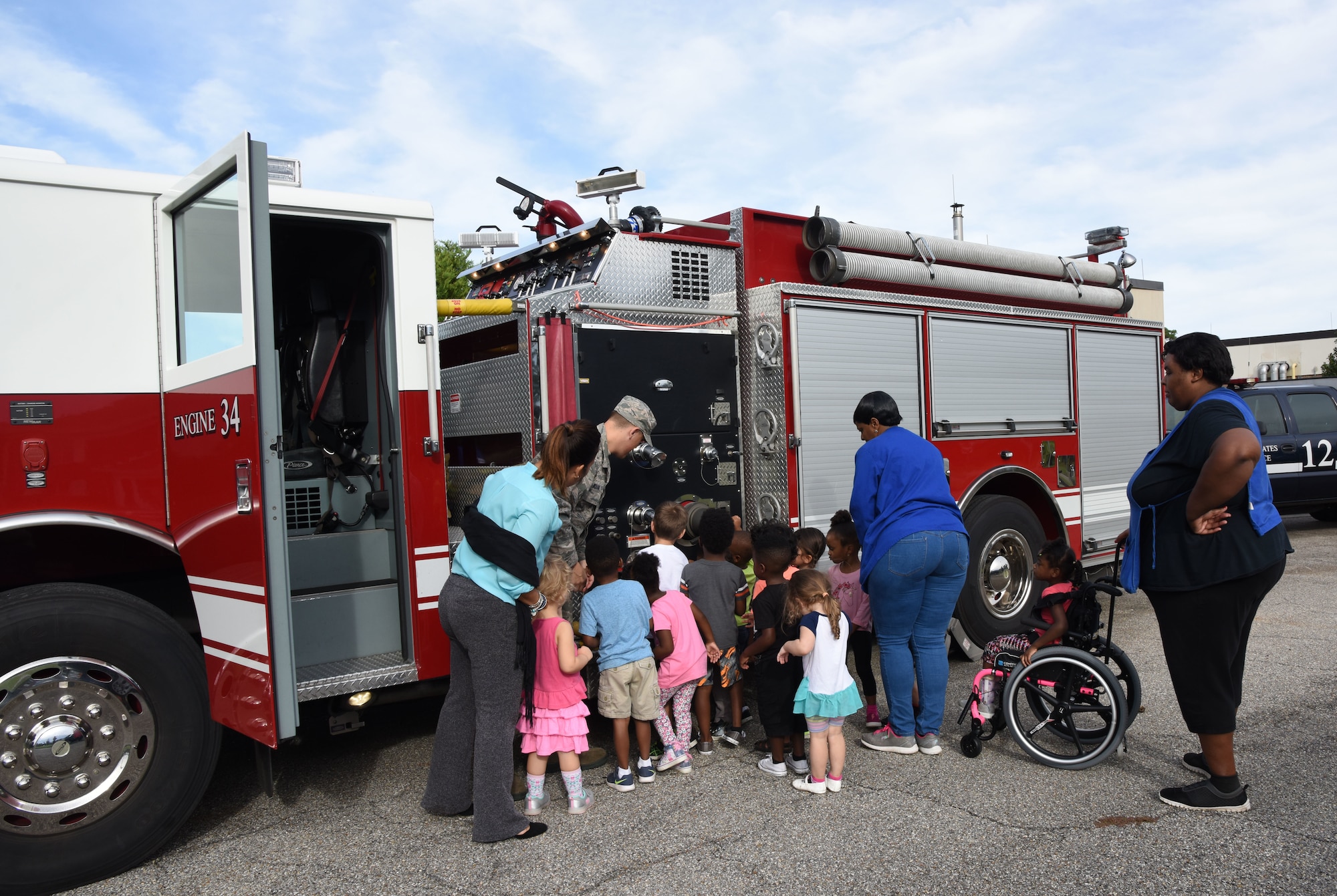 Keesler Child Development Center children receive a tour of a a fire truck during Fire Prevention Week outside of the CDC on Keesler Air Force Base, Mississippi, Oct. 10, 2018. The week-long event included fire drills, literature hand-outs and stove fire demonstrations around the base and concluded with an open house at the fire department Oct. 13. (U.S. Air Force photo by Kemberly Groue)