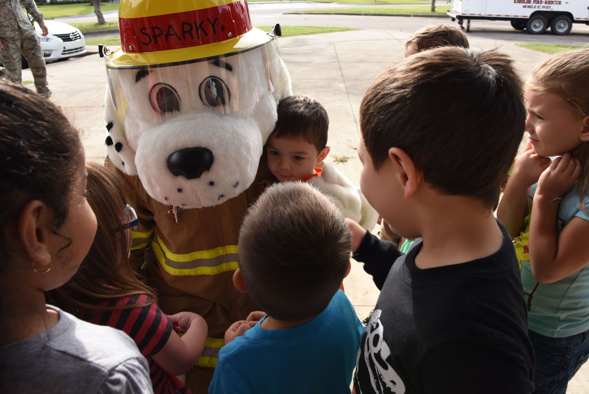 Sparky, the Fire Dog, visits children at the Child Development Center during Fire Prevention Week on Keesler Air Force Base, Mississippi, Oct. 10, 2018. The week-long event included fire drills, literature hand-outs and stove fire demonstrations around the base and concluded with an open house at the fire department Oct. 13. (U.S. Air Force photo by Kemberly Groue)