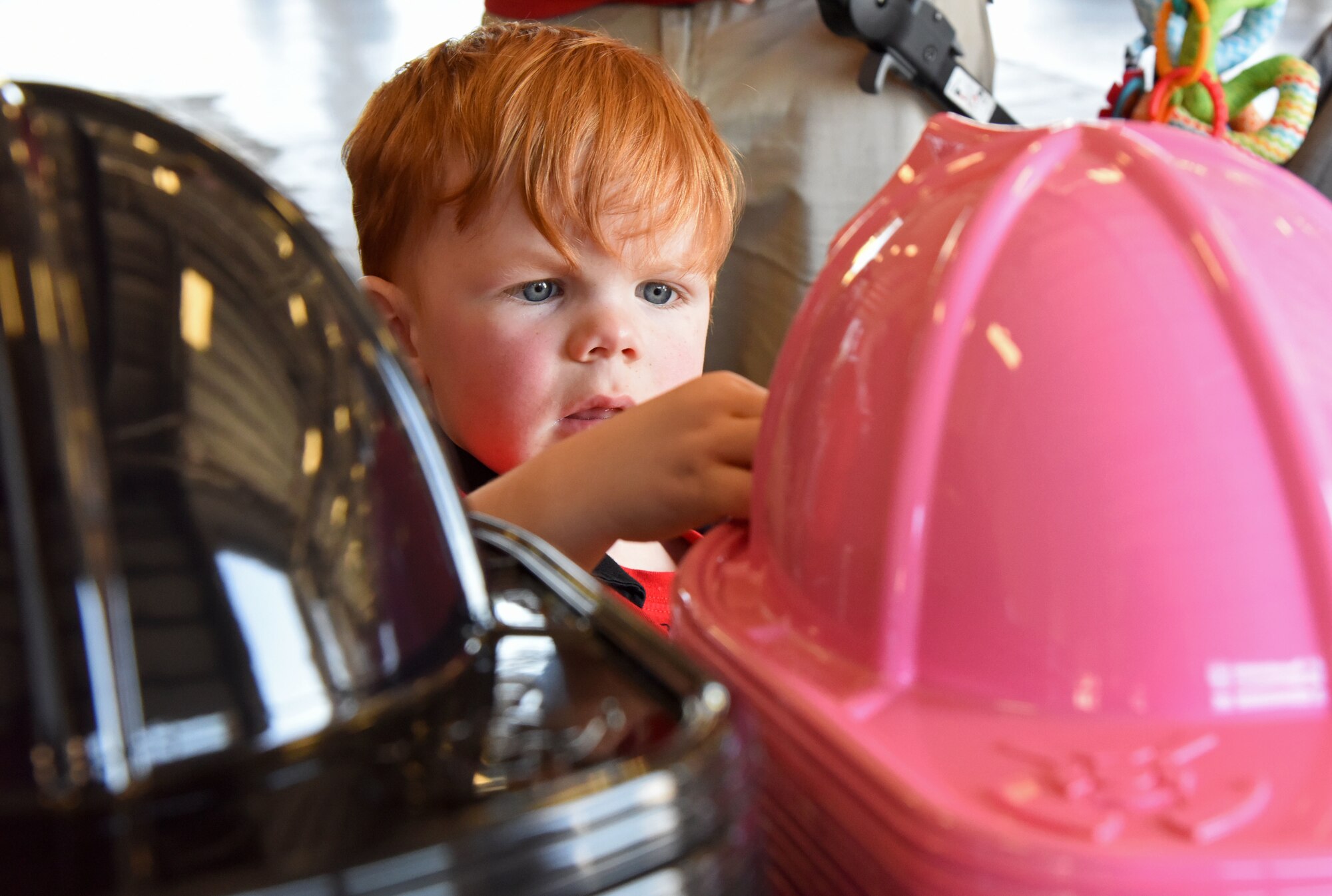 Brayden Pettus, son of James Pettus, 81st Infrastructure Division firefighter, selects a fire hat during a open house at the fire station at Keesler Air Force Base, Mississippi, Oct. 13, 2018. Keesler ended its Fire Prevention Week celebration with  an open house which consisted of displays, fire truck rides and fire prevention demonstrations. (U.S. Air Force photo by Kemberly Groue)