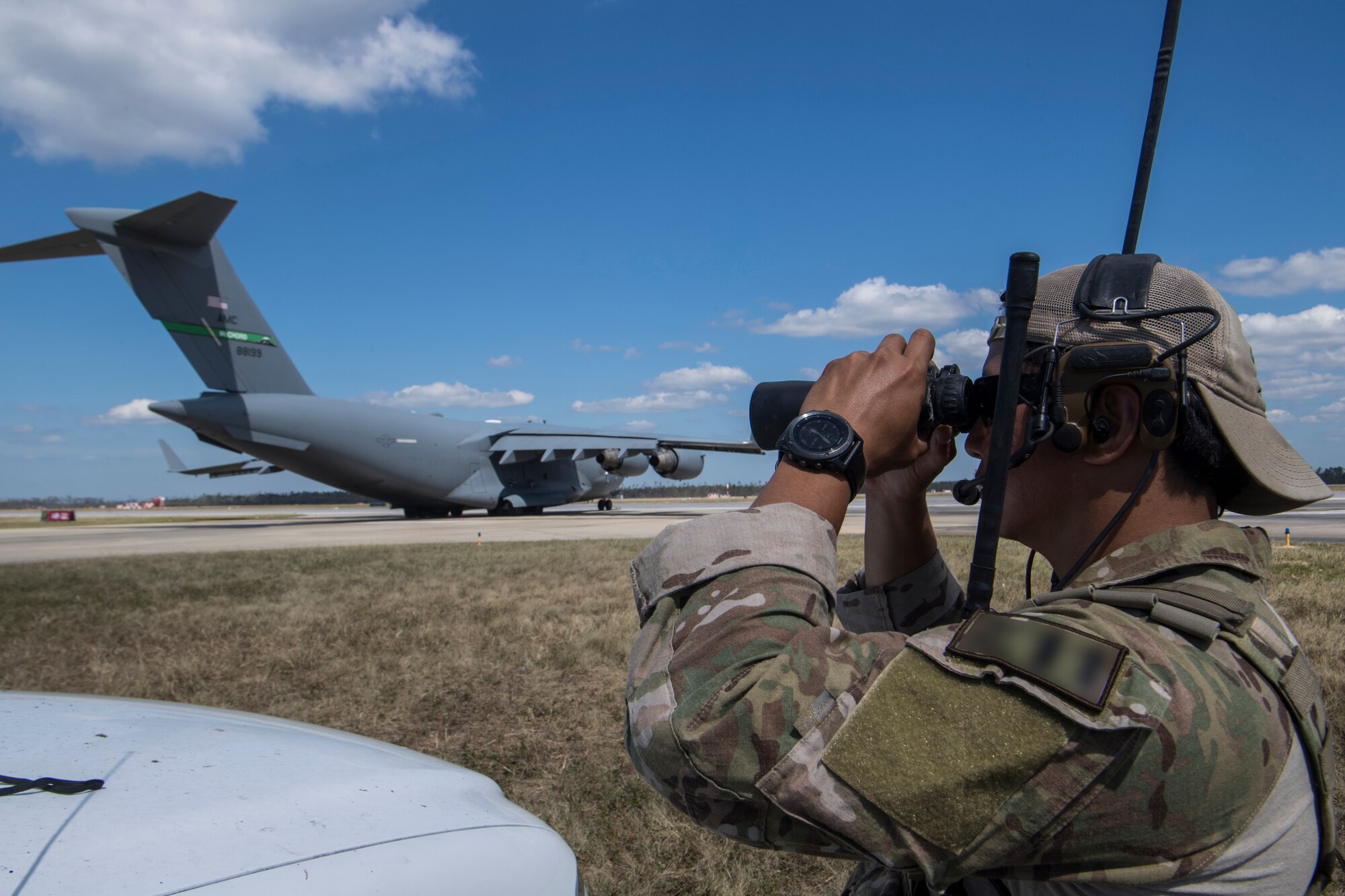 A Special Tactics Airman with the 23rd Special Tactics Squadron looks through binoculars at Tyndall Air Force Base, Florida, Oct. 14, 2018.