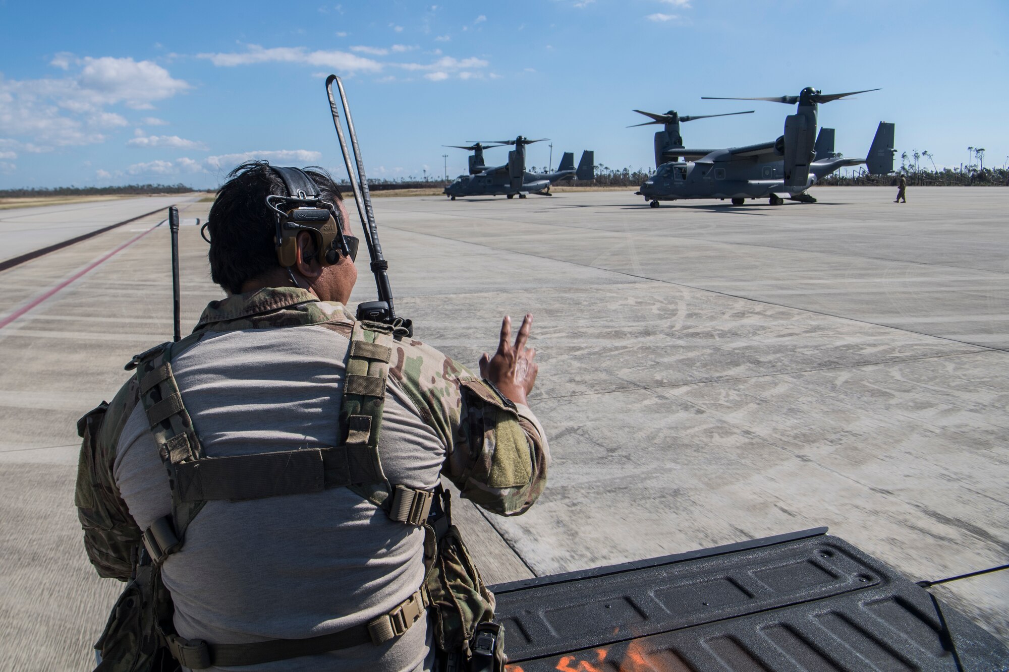 A Special Tactics Airman with the 23rd Special Tactics Squadron waves to a CV-22 Osprey tiltrotor aircraft assigned to the 8th Special Operations Squadron at Tyndall Air Force Base, Florida, Oct. 14, 2018.