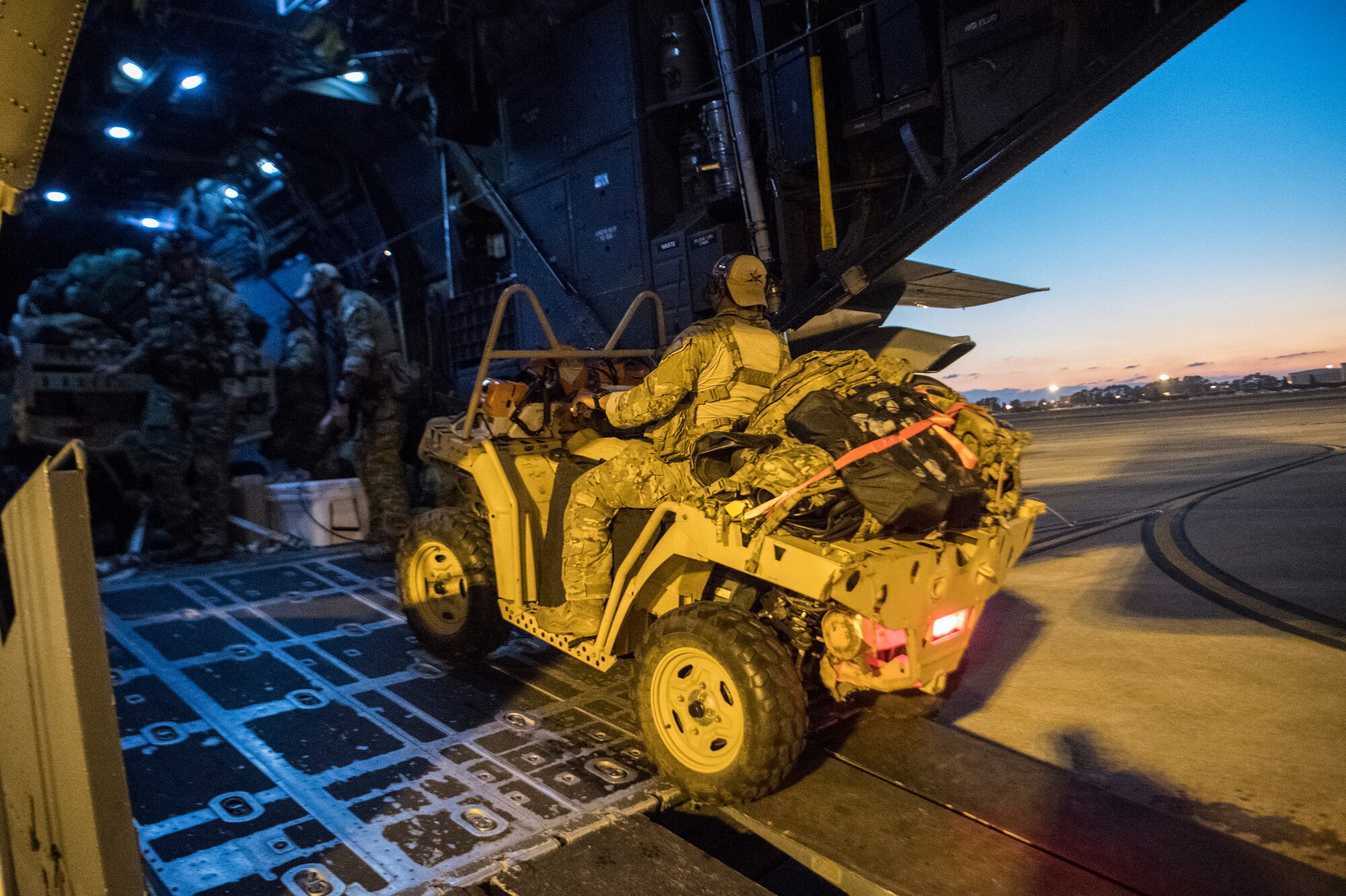 A Special Tactics Airman with the 23rd Special Tactics Squadron drives an all-terrain vehicle off an MC-130H Combat Talon II assigned to the 15th Special Operations Squadron upon returning to Hurlburt Field, Florida, Oct. 14, 2018.
