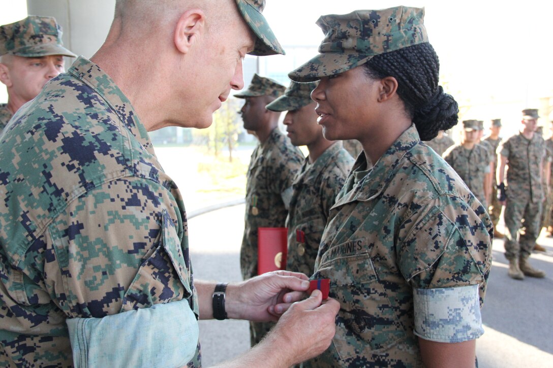 USAG CAMP HUMPHREYS, Republic of Korea – Maj. Gen. Patrick J. Hermesmann (left), commander of U.S. Marine Corps Forces Korea, awards Cpl. Daejahne Williams, MARFORK G-1 Outbound/Inbound non-commissioned officer, the Good Conduct Medal here, Oct. 4. MARFORK awarded Williams the medal for demonstrating the character expected of a Marine and within the highest standards of Marine Corps ethos. (U.S. Marine Corps photo by Staff Sgt. Anthony Kirby/Released)