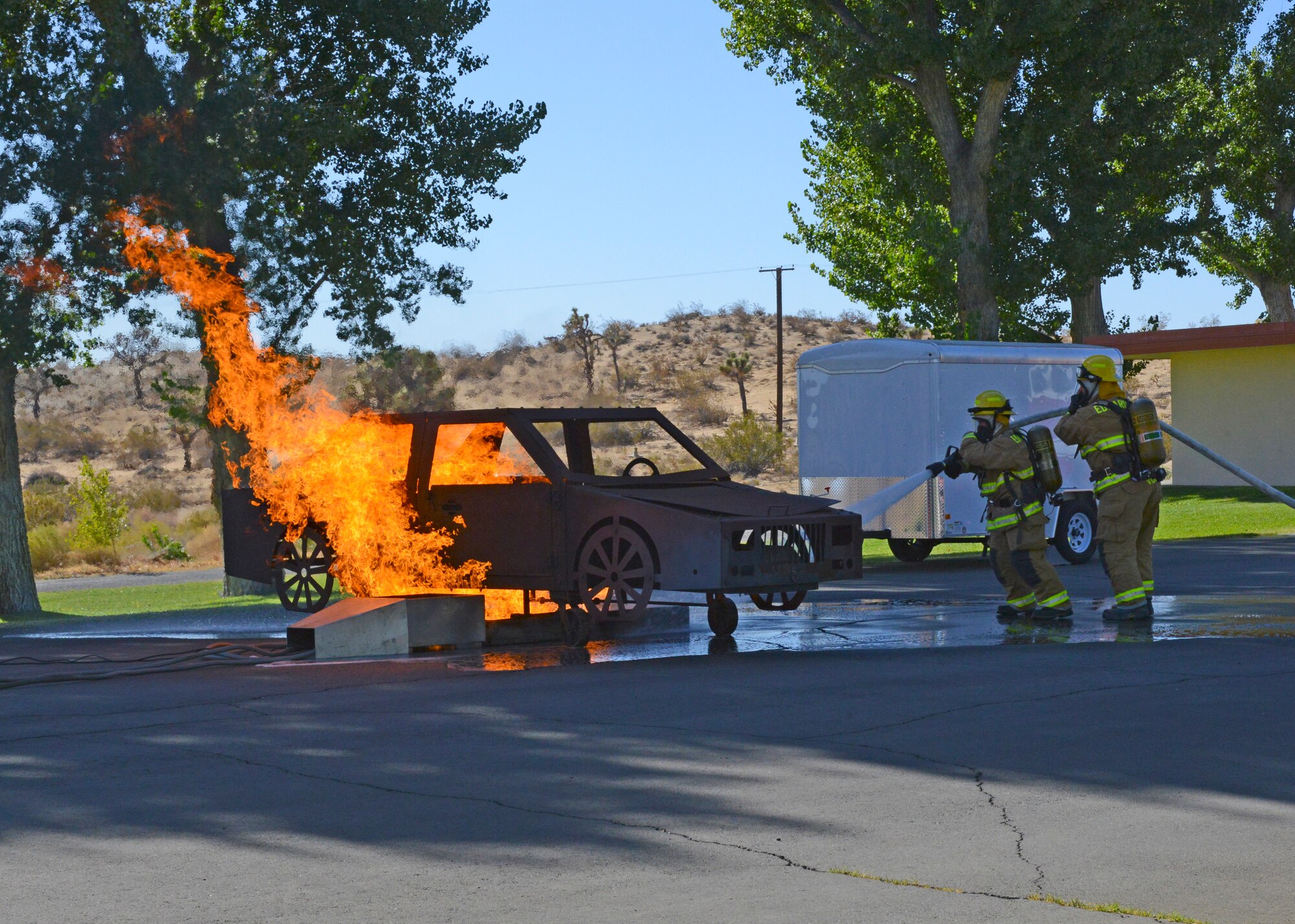 Edwards AFB fire fighters demonstrate how they would put out a car fire during an open house at Fire Station #4 at the Air Force Research Laboratory Detachment 7, Oct. 11. (U.S. Air Force photo by Kenji Thuloweit)