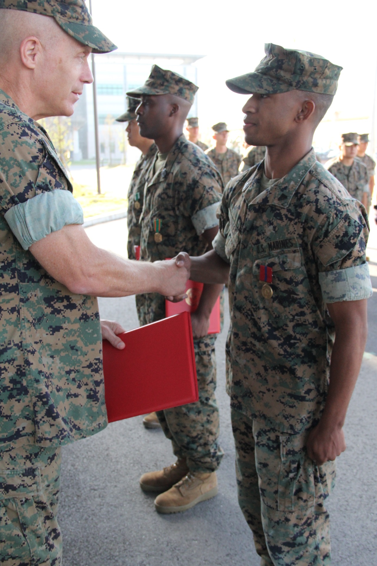 USAG CAMP HUMPHREYS, Republic of Korea – Maj. Gen. Patrick J. Hermesmann (left), commander of U.S. Marine Corps Forces Korea, awards Cpl. Eric Dates, MARFORK G-1 Outbound/Inbound non-commissioned officer, a Good Conduct Medal here, Oct. 4. MARFORK awarded Dates the medal for demonstrating character expected of a Marine within the highest standards of Marine Corps ethos. (U.S. Marine Corps photo by Staff Sgt. Anthony Kirby/Released)
