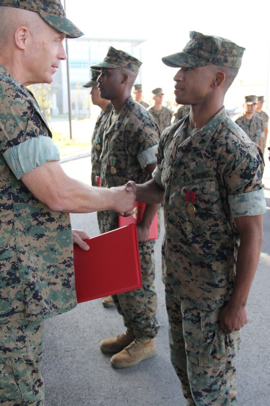 USAG CAMP HUMPHREYS, Republic of Korea – Maj. Gen. Patrick J. Hermesmann (left), commander of U.S. Marine Corps Forces Korea, awards Cpl. Eric Dates, MARFORK G-1 Outbound/Inbound non-commissioned officer, a Good Conduct Medal here, Oct. 4. MARFORK awarded Dates the medal for demonstrating character expected of a Marine within the highest standards of Marine Corps ethos. (U.S. Marine Corps photo by Staff Sgt. Anthony Kirby/Released)