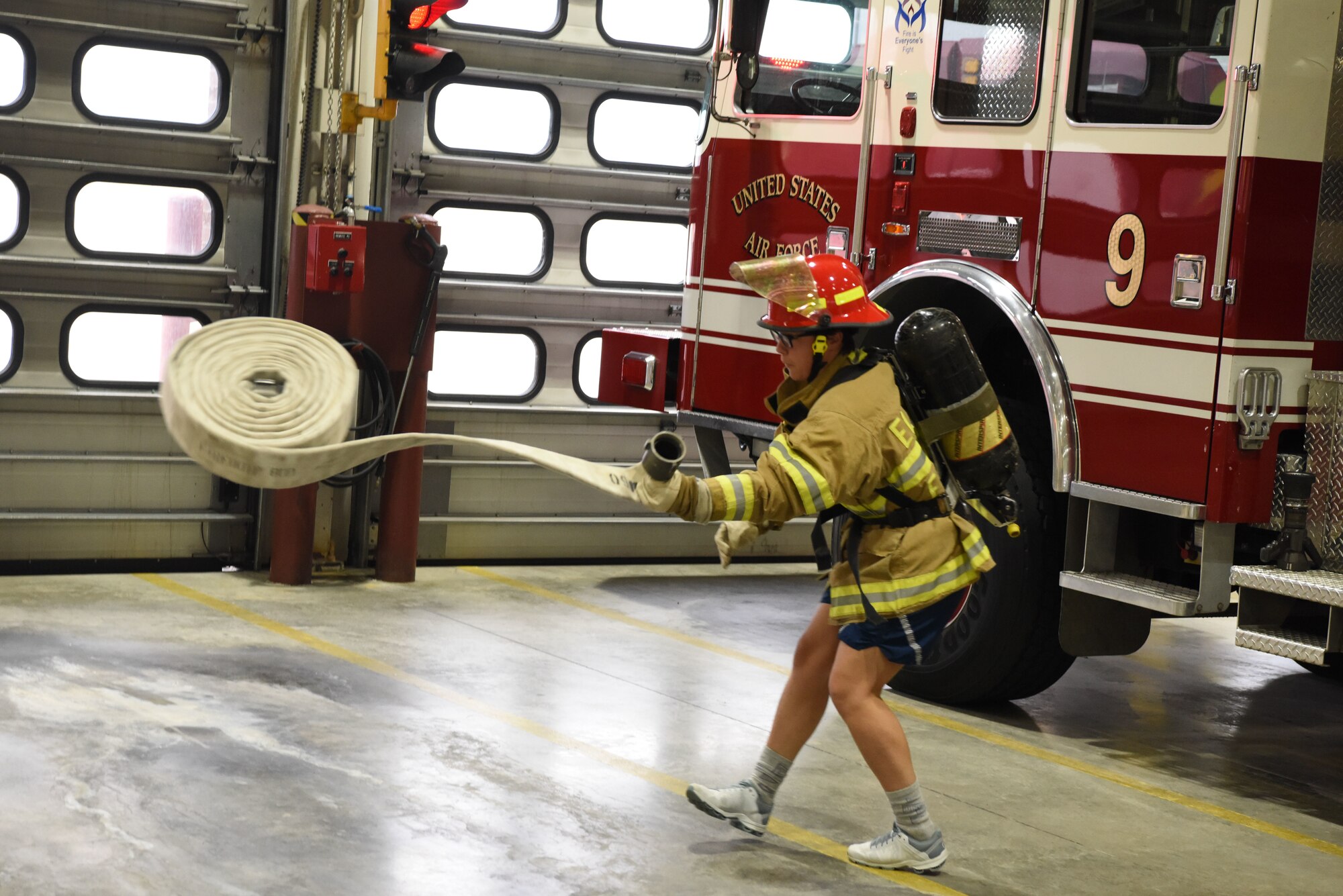 Airman 1st Class Michelle Medina, a 28th Logistics Readiness Squadron fuels facility operator, unravels a hose during the Firefighter Challenge at Ellsworth Air Force Base, S.D., Oct. 5, 2018. The challenge was one many events hosted by the 28th Civil Engineer Squadron fire protection flight during National Fire Prevention and Safety Week. (U.S. Air Force photo by Airman 1st Class Thomas Karol)