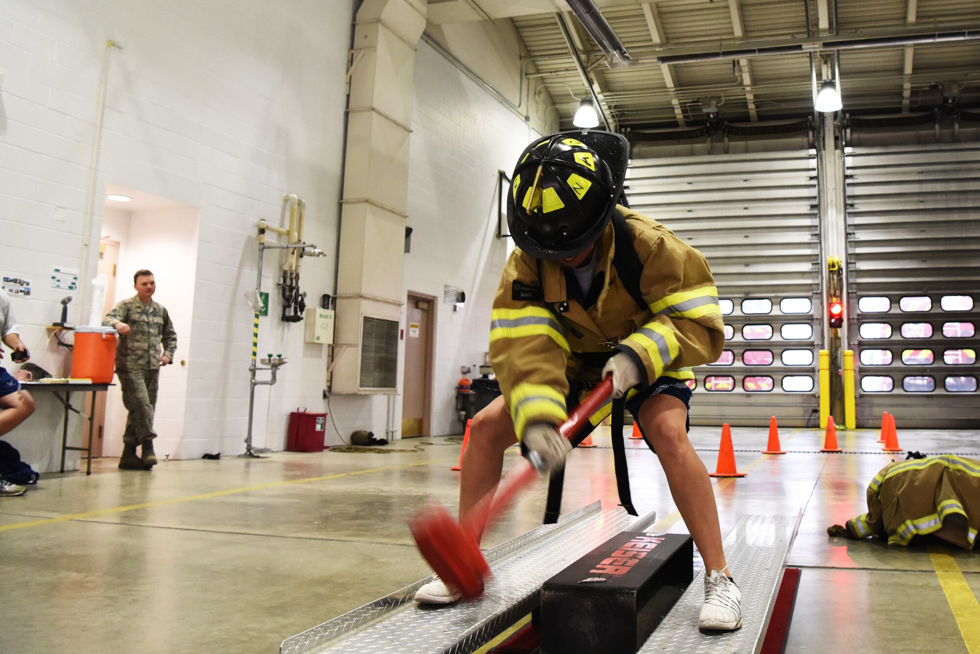 Senior Airman Caitlyn Halloway, a 28th Logistics Readiness Squadron vehicle maintenance technician, hits the Kaiser I-beam of a FORCE Machine with a sledgehammer during the Firefighter Challenge at Ellsworth Air Force Base, S.D., Oct. 5, 2018. The 28th Civil Engineer Squadron fire protection flight hosted multiple events during National Fire Prevention and Safety Week, including the Firefighter Challenge, a parade and school demonstrations. (U.S. Air Force photo by Airman 1st Class Thomas Karol)