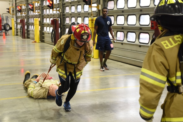 Capt. Saira McGan, a 28th Logistics Readiness Squadron operations officer, pulls a training dummy while racing through the Firefighter Challenge at Ellsworth Air Force Base, S.D., Oct. 5, 2018. The 28th Civil Engineer Squadron fire protection flight hosted multiple events during National Fire Prevention and Safety Week, including a Firefighter Challenge, a parade and school demonstrations. (U.S. Air Force photo by Airman 1st Class Thomas Karol)