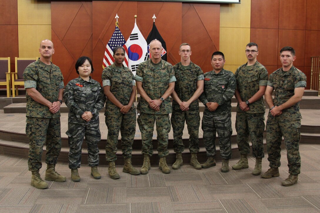 CAMP HUMPHREYS, Republic of Korea – Maj. Gen. Patrick J. Hermesmann (center), commander of U.S. Marine Corps Forces Korea, and Sgt. Maj. Michael R. Saucedo (far left), sergeant major of MARFORK, congratulate U.S. and Republic of Korea Marines at their graduation for Backbone University here, Oct. 12. Backbone University, which supports Combined Forces Command, United Nations Command, and U.S. Forces Korea, teaches the non-commissioned officers about NCO leadership in a combined joint operating environment. (U.S. Marine Corps photo by Sgt. Nathaniel Hanscom/Released)